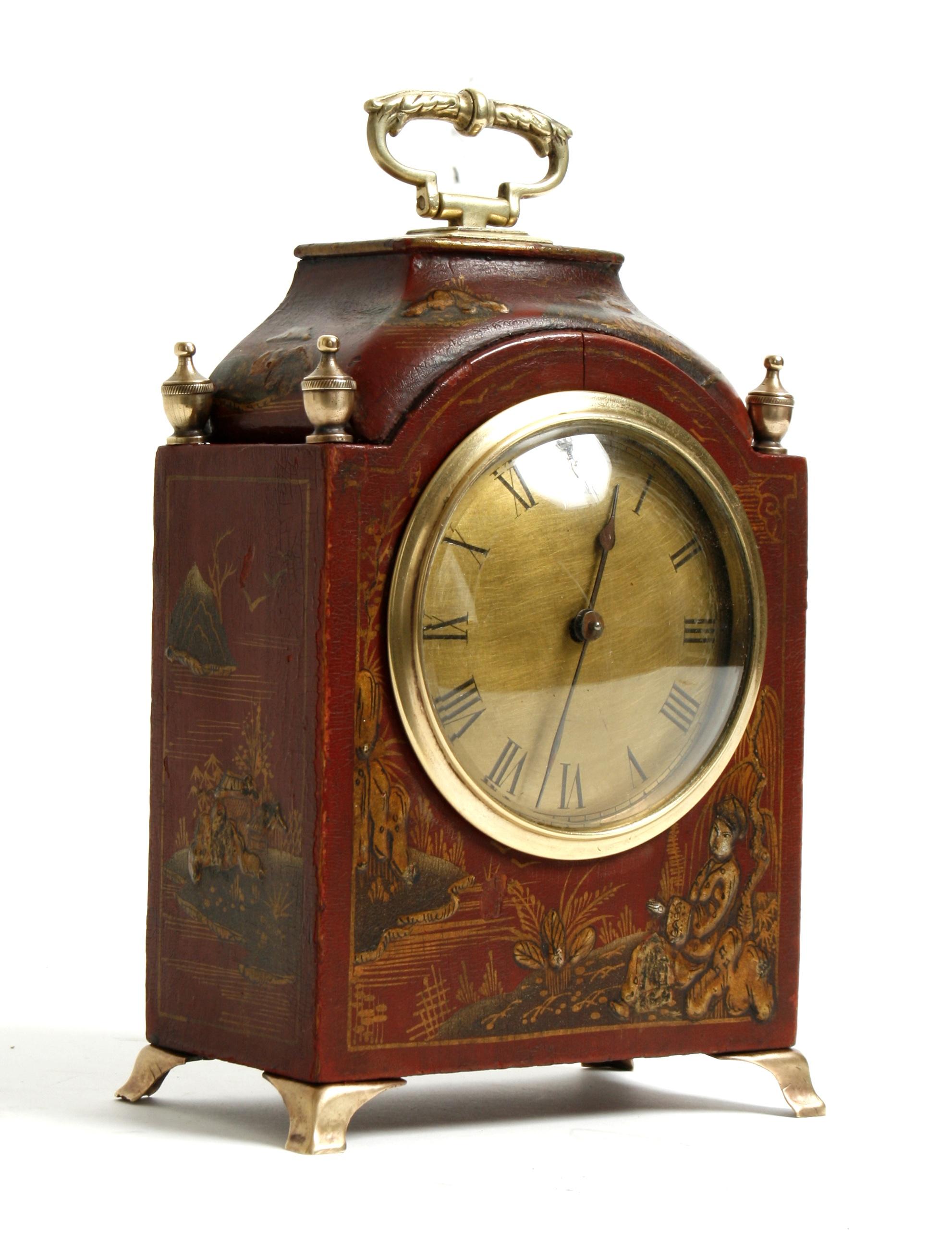 This beautiful clock containing later French works is decorated with scenes of Asian country life. It has a decorative brass handle, finials, face and legs. The wooden case is painted red with raised details of gold and brown. A charming timepiece.