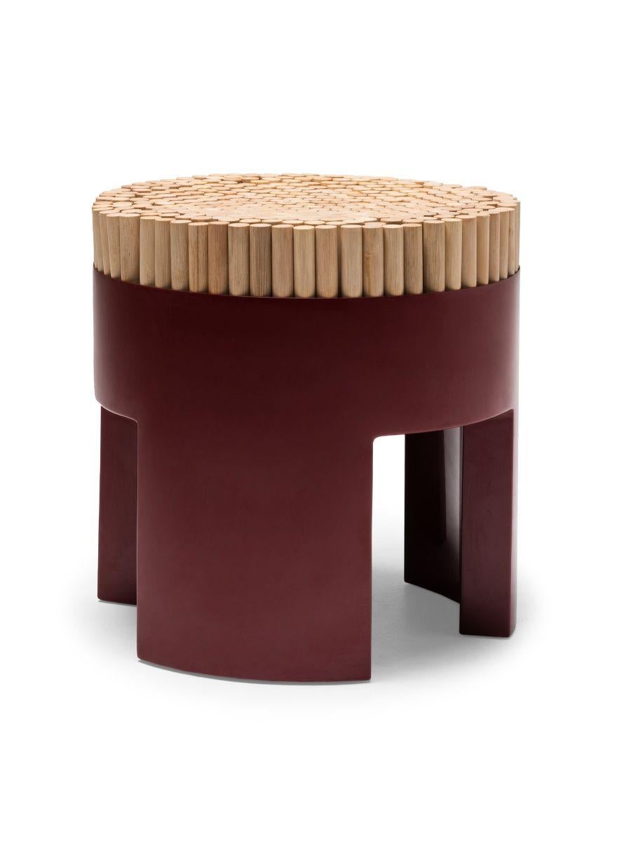 Chiquita red stool by Kenneth Cobonpue.
Materials: Rattan, Polyurethane foam, steel. 
Dimensions: Diameter 45 cm x height 46 cm 

Chiquita is a bundle of charms with its clever design and functionality. The Chiquita stool’s vertical sections of