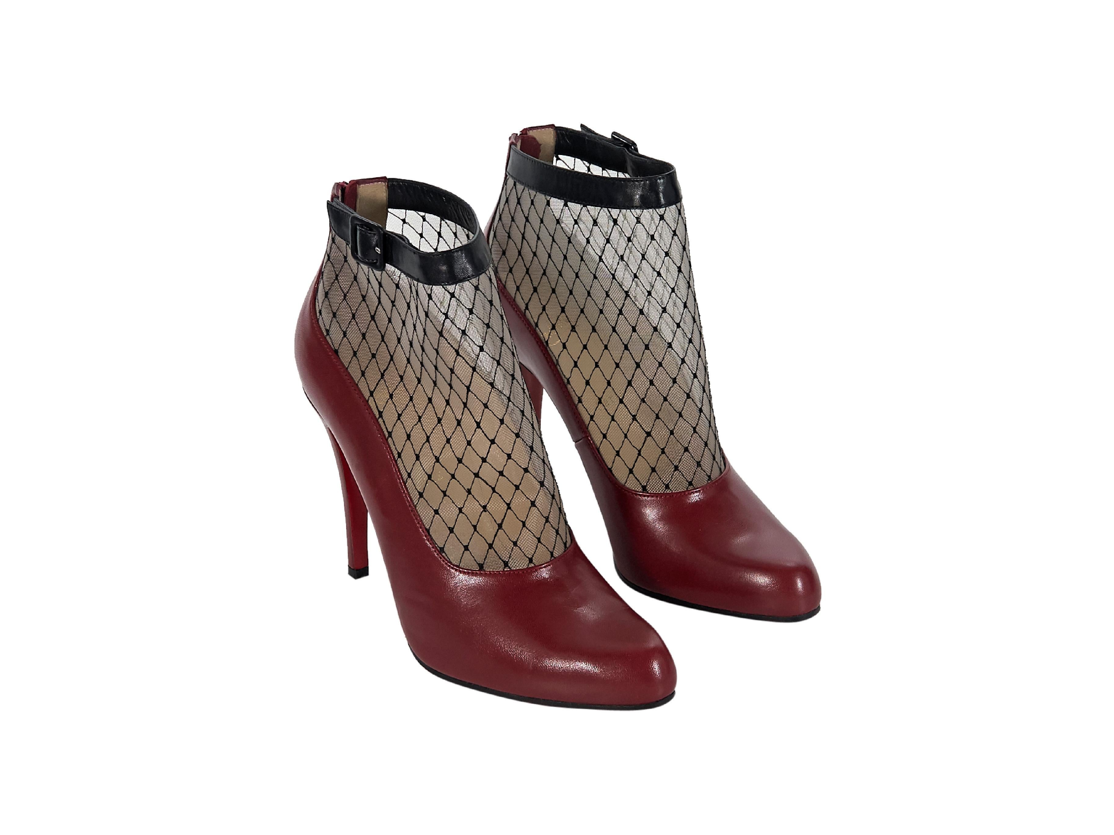 Product details:  Red leather fishnet ankle boots by Christian Louboutin.  Trimmed with a buckle strap detail.  Back zip closure.  Round toe.  Iconic red sole.  Label size IT 39.  4.75