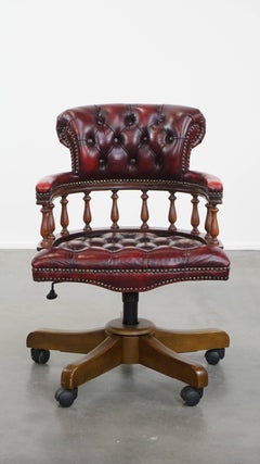 Red classic swivel cowhide Chesterfield office chair on wheels