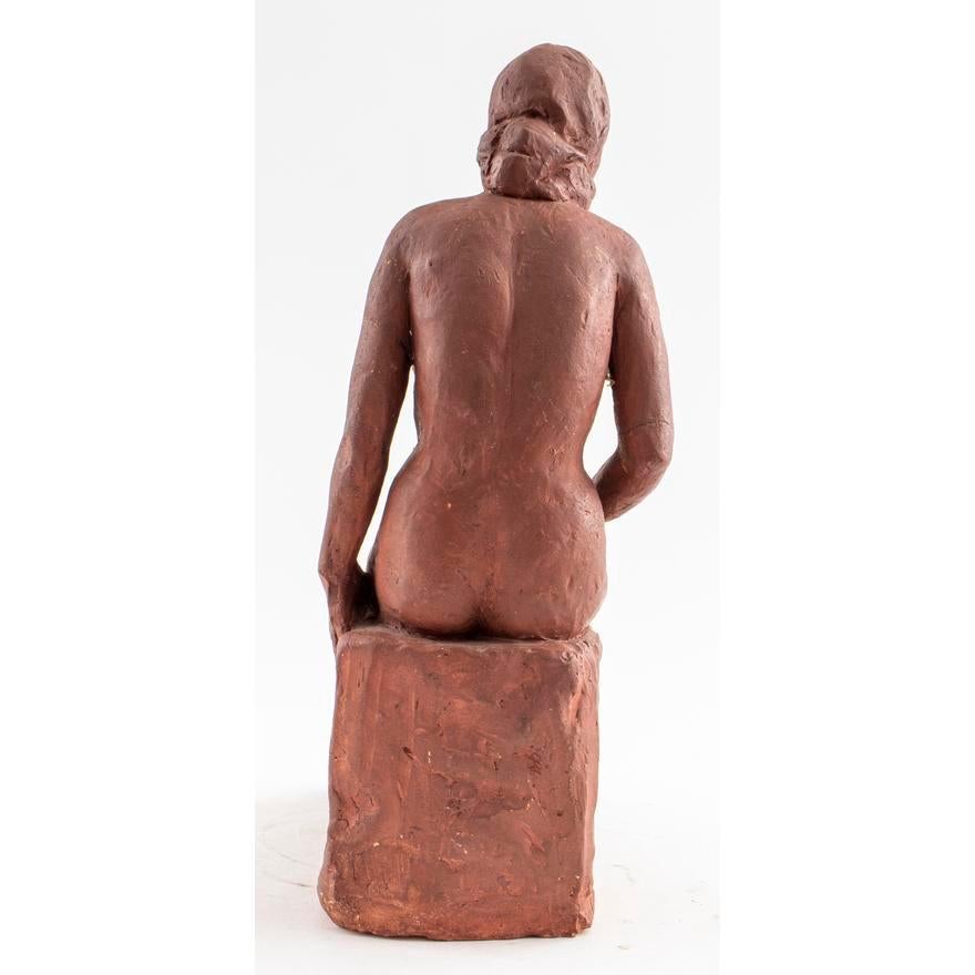 Red clay sculpture of a seated nude. 14 1/2