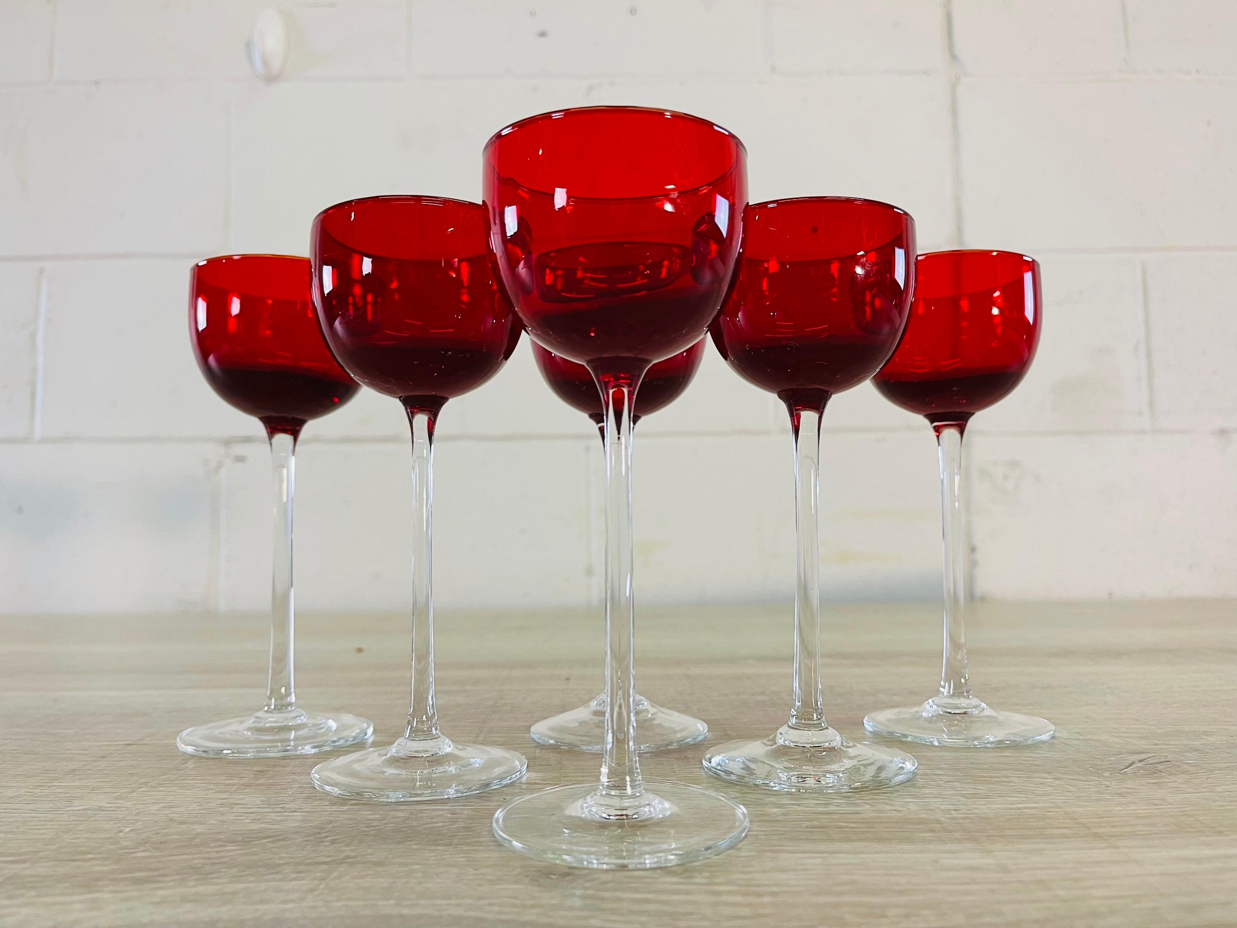 Vintage set of six red and clear glass tall cordial stems. No marks.