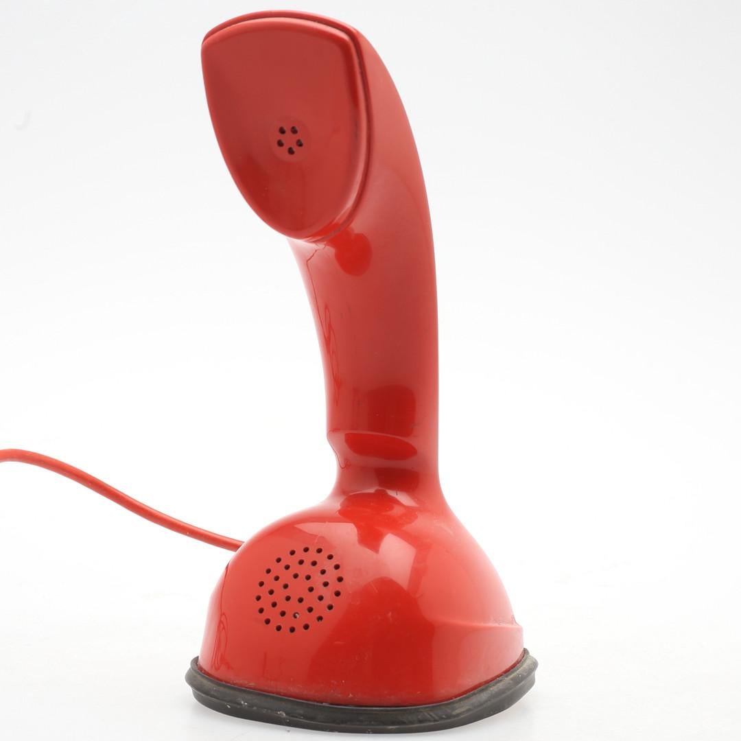 Vintage Rotary dial red ericofone. This is the model Cobra. It is made of thermoplastic ABS
Designed in the 1950s in Sweden by Hugo Blomberg, Ralph Lysell and Gösta Thames, LM Ericsson.
 