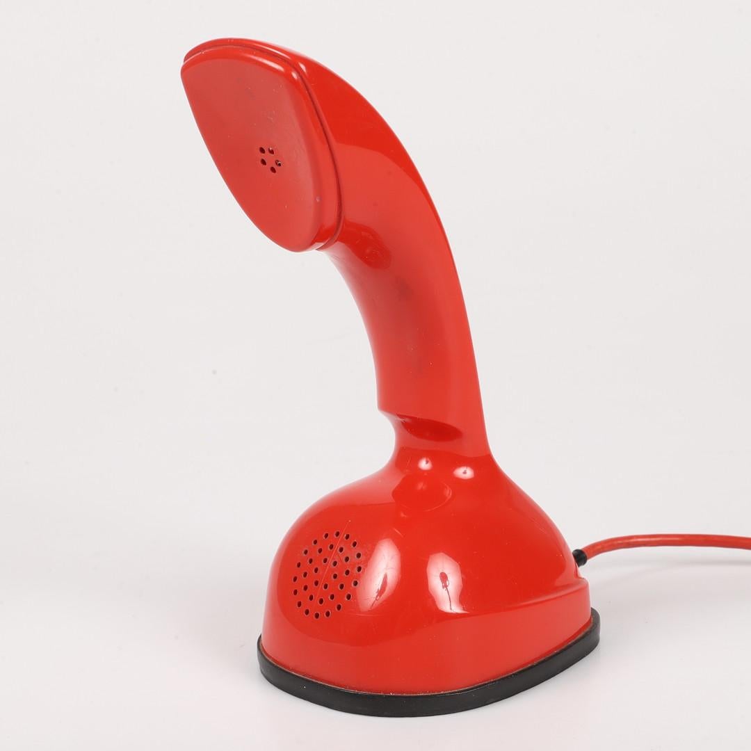 Vintage Rotary dial red ericofone. This is the model Cobra. It is made of thermoplastic ABS
Designed in the 1950s in Sweden by Hugo Blomberg, Ralph Lysell and Gösta Thames, LM Ericsson.
 