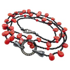 Collana di corallo rosso e ematite nera con cerchi di zaffiro bianco