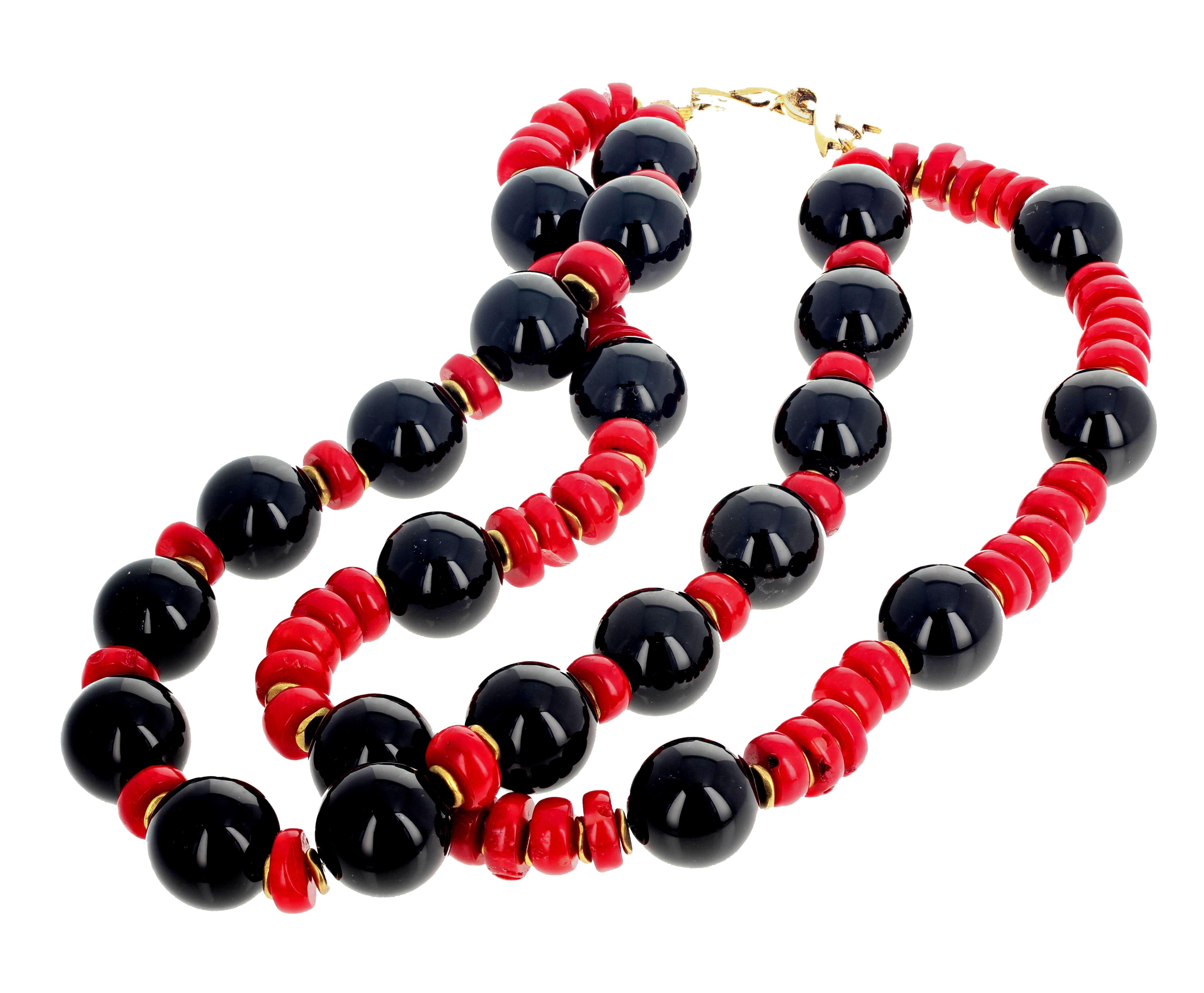 Double strand of highly polished glowing natural black Onyx (18 mm) enhanced with rondels of natural red Bamboo Coral set in this double strand necklace with gold tone easy to use hook clasp.  This necklace is 17 inches long and sits elegantly