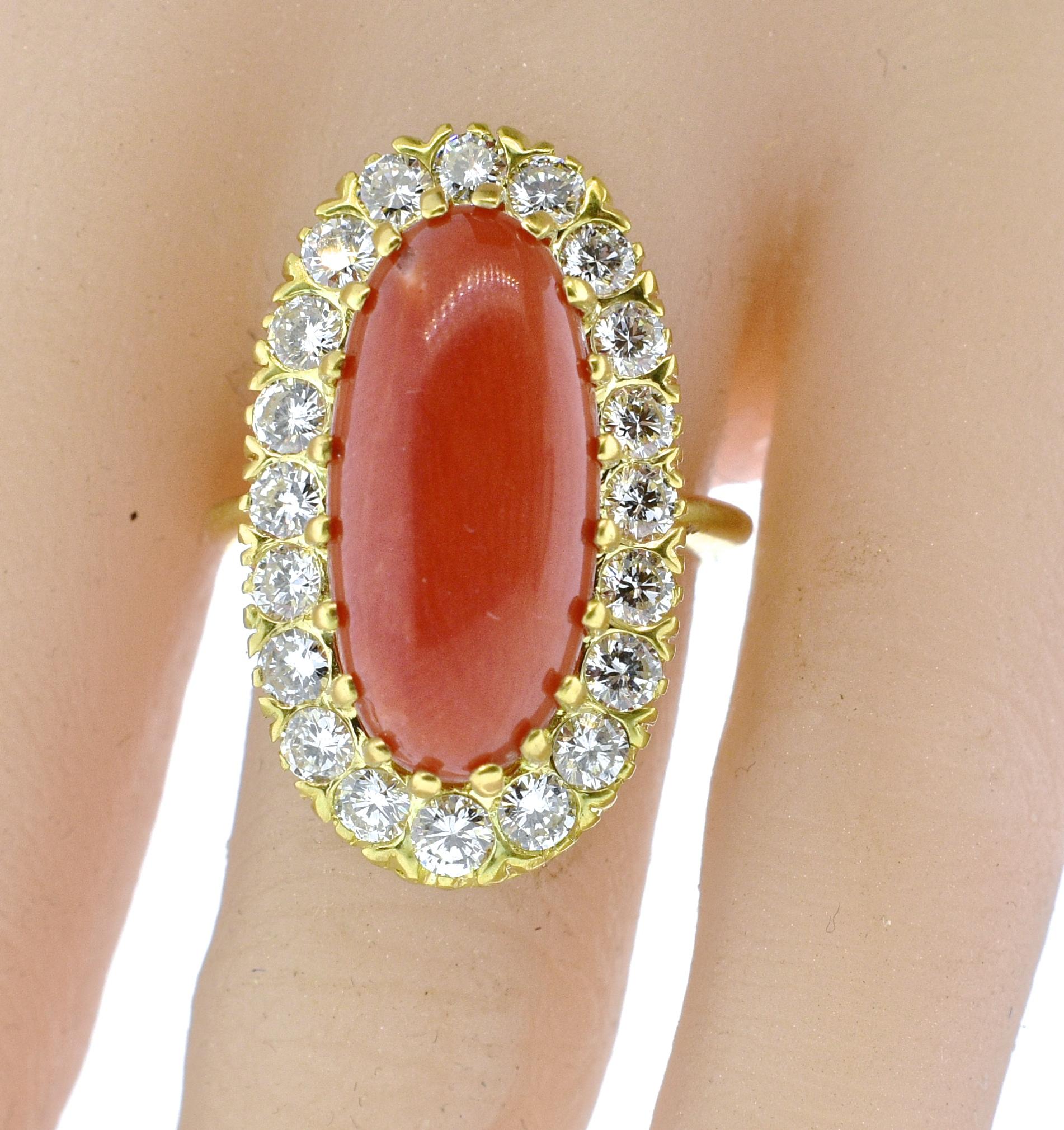Red coral from the Mediterranean is surrounded with fine white brilliant cut diamonds all hand set in 18K.  The natural coral in a very pleasing shape, weighs approximately 6 cts and is surrounded by 1.85 cts of fine white brilliant cut diamonds. 