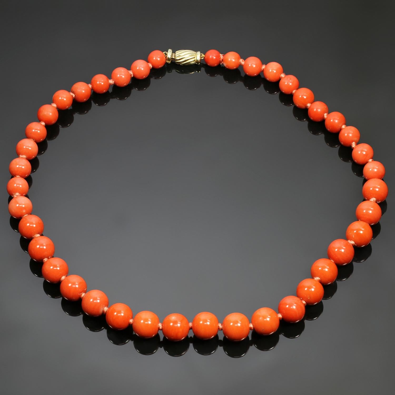 This rare vintage necklace is composed of genuine coral beads forming a graduated strand and ranging in size from 7.50mm to 12.00mm. Completed with a 14k yellow gold clasp accented by a single-cut diamond. Made in Italy circa 1980s. Measurements:
