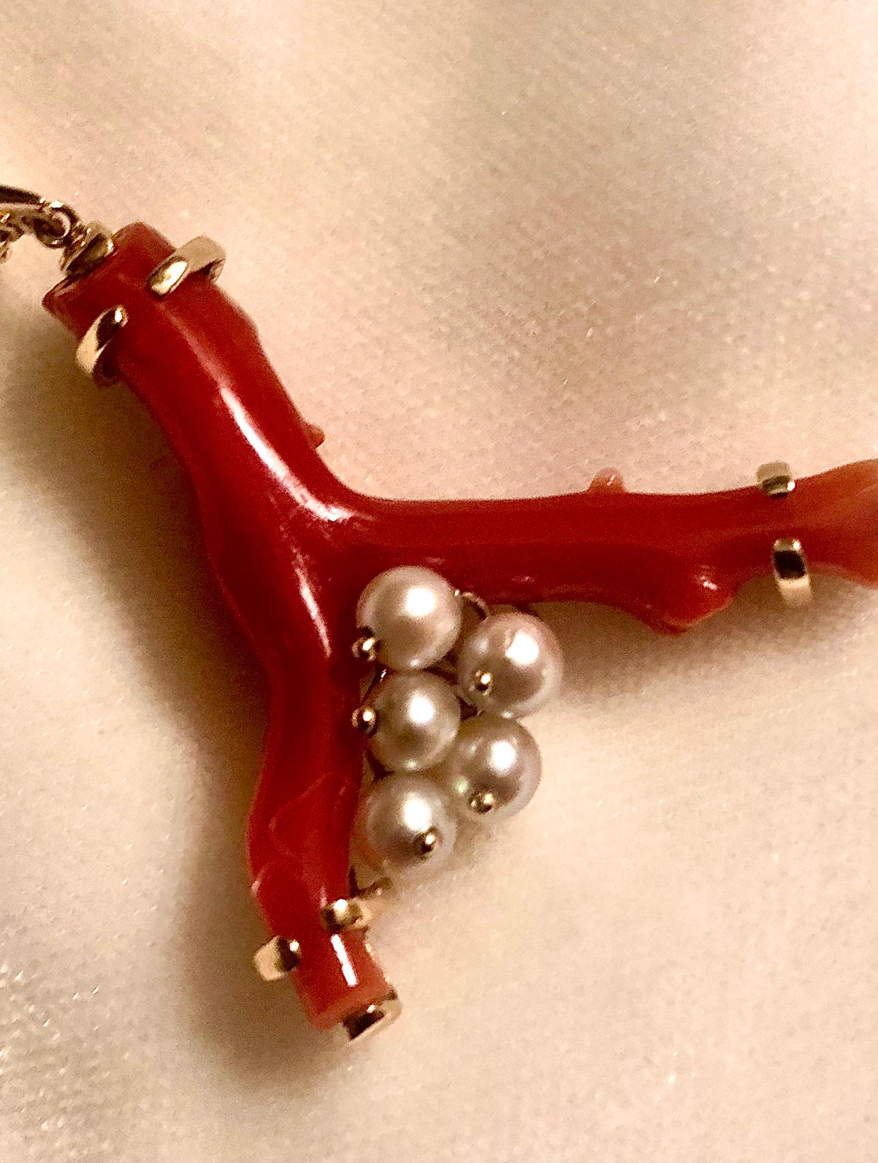 ﻿This is a beautiful pendant of a flawless red Sardinian coral branch. The coral is very smoothly polished with discolored or pitted areas. Gem quality not often found today.

The branch is accented with five lustrous white 5.5mm pearls on gold