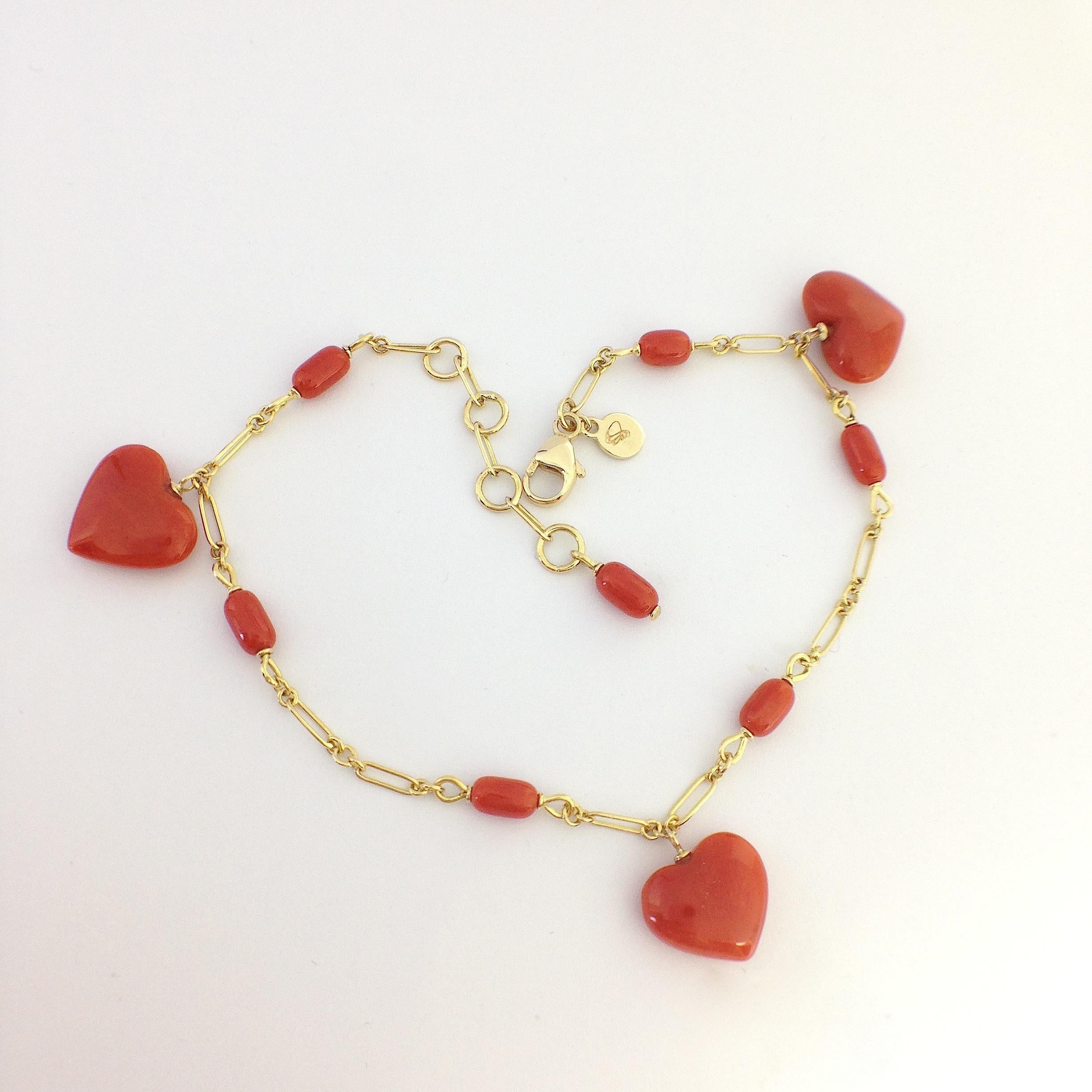 This bracelet is totally handmade in 18 kt gold.
It is interspersed with natural red coral oval beads (about mm 3x5) and three dangle natural red coral equidistant from each other.

As you can see on the picture, you can wear the bracelet from 18 
(
