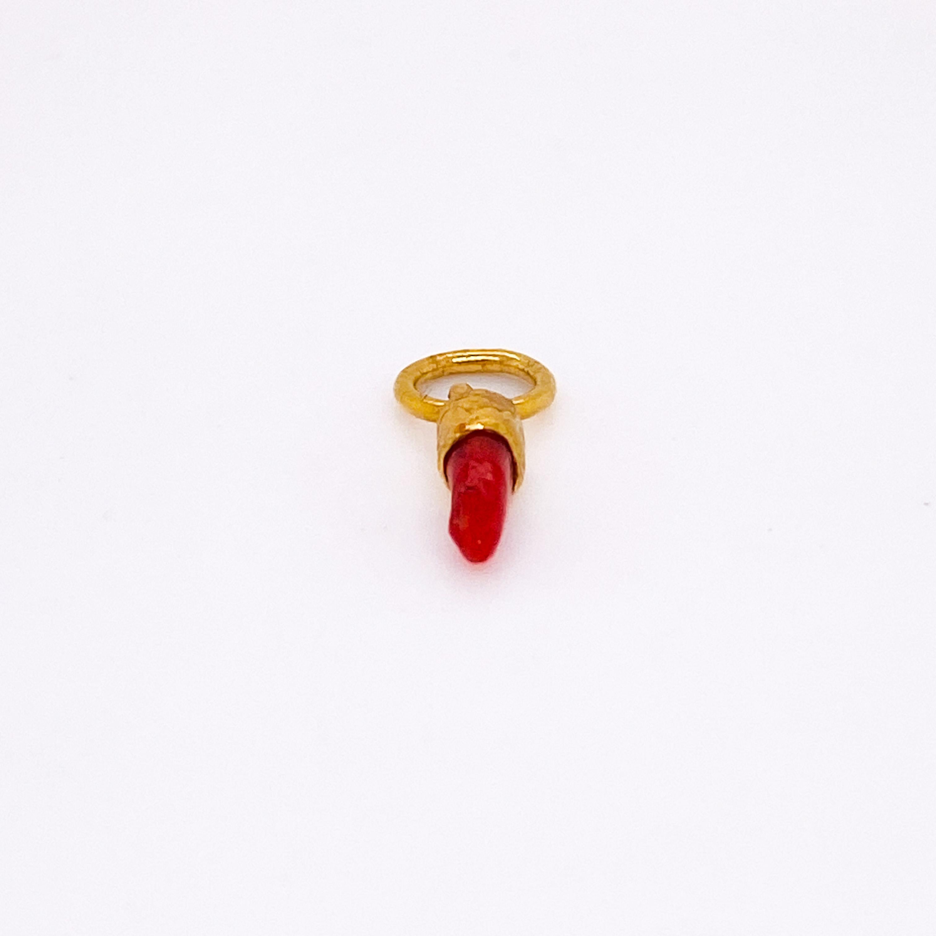 This unique 24 karat pure gold pendant (or charm) has a piece of red coral set in it. The pendant is handmade from 24 karat gold and looks great on any chain or charm bracelet. The coral is sourced from the Adriatic Sea around Croatia. There is only