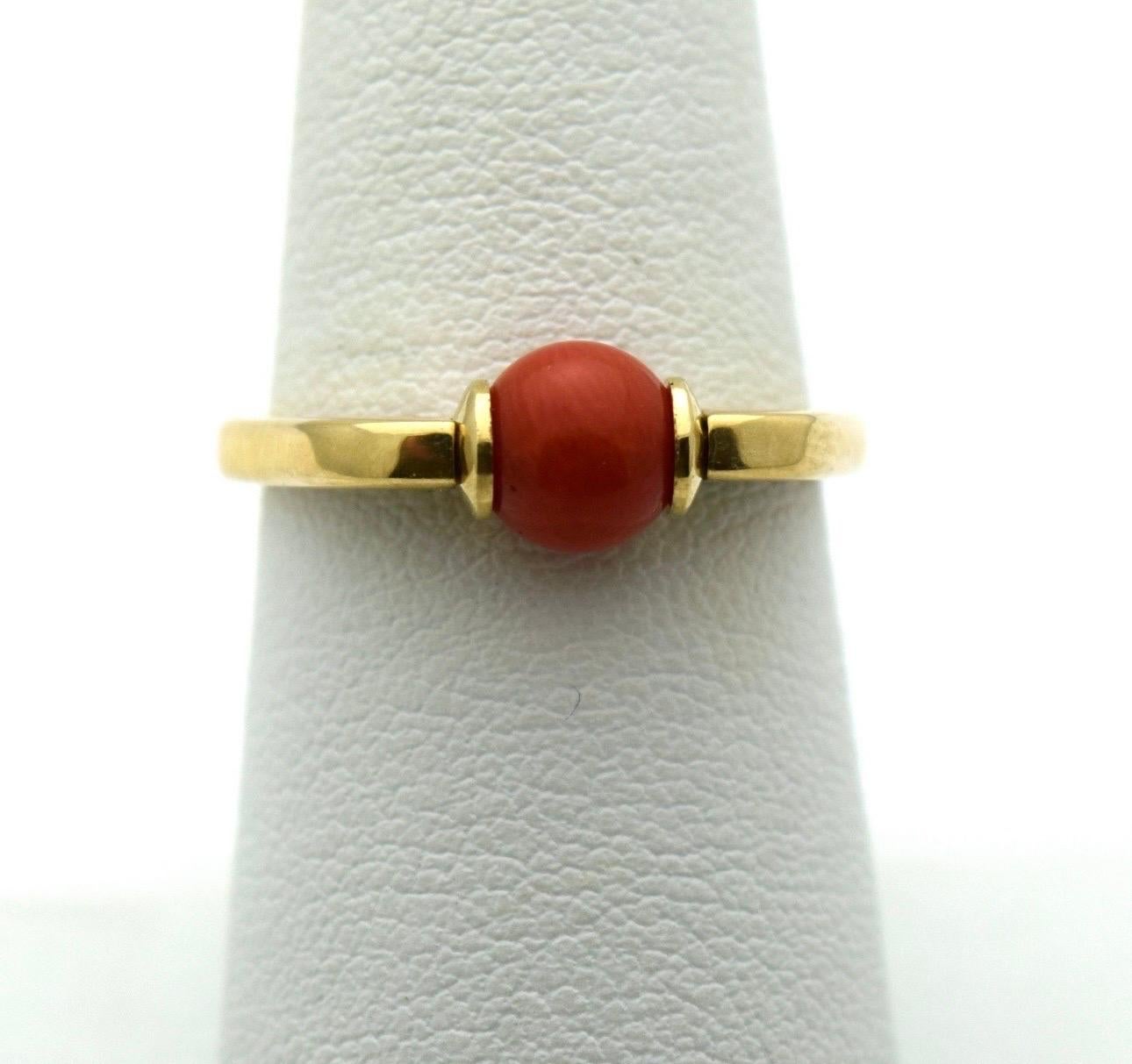 A modern ring indeed with a coral touching the skin which is believed by many cultures to be a poweful stone. Coral is about 6mm bead natural red coral undyed. The ring is made in modern style in 18KT gold.

Certificate of authenticity comes with