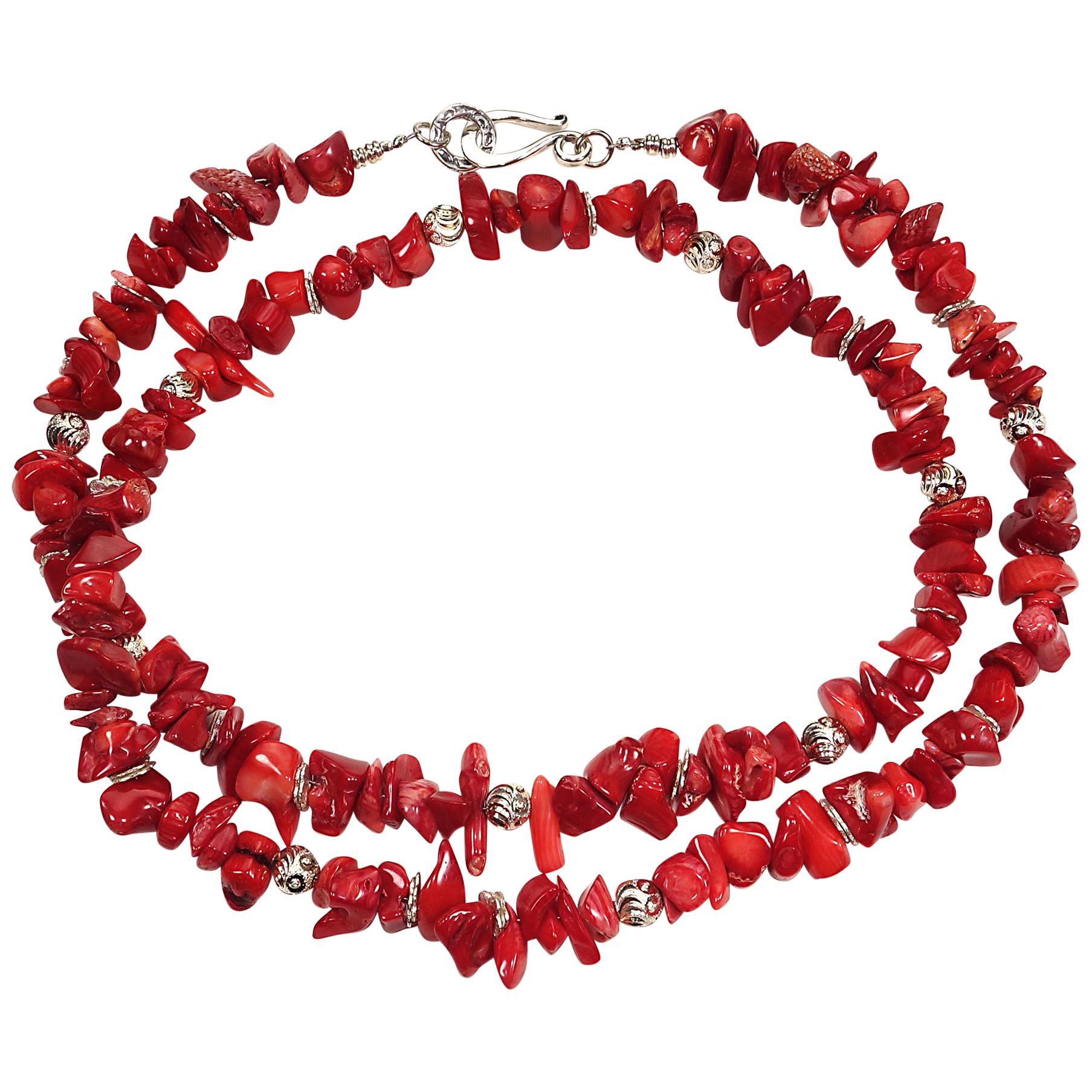 27 Inch necklace of Red Coral chips with silver toned accents.  These highly polished Red Coral chips are a lovely bright red and have all the natural beauty marks of coral.  This unique necklace is secured with a Sterling Silver hook and eye clasp.