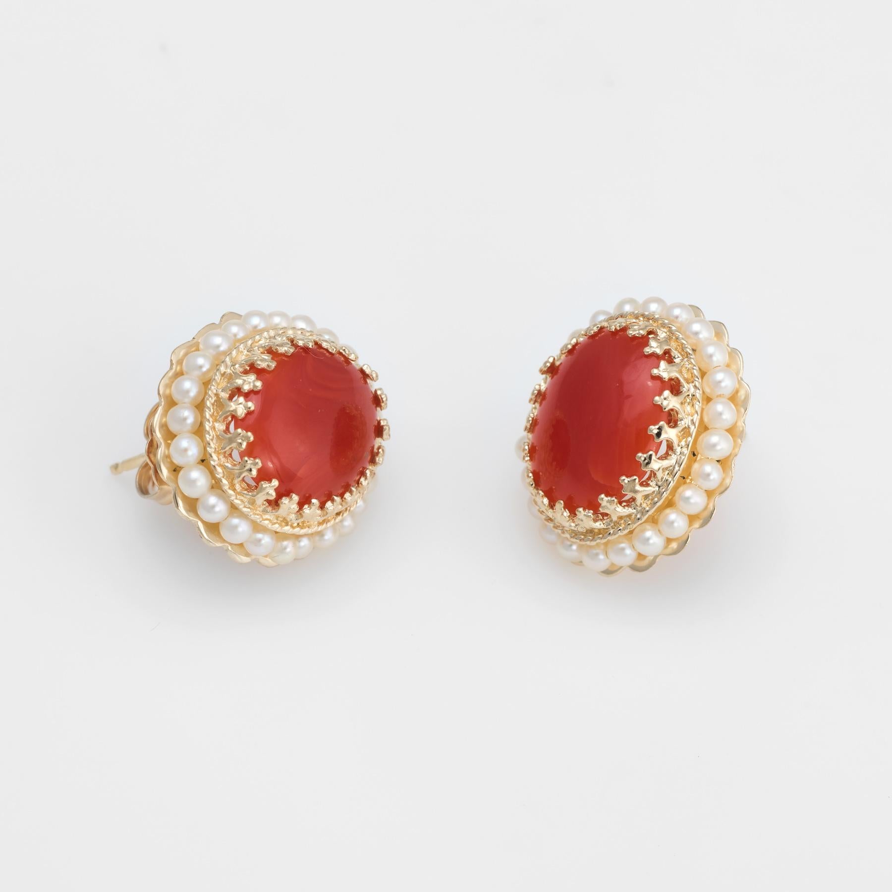 Elegant pair of estate red coral and seed pearl earrings, crafted in 14k yellow gold. 

Cabochon cut red coral measures 12mm x 10mm (estimated at 5 carats each - 10 carats total estimated weight). The seed pearls measure (average) 2mm. The coral is