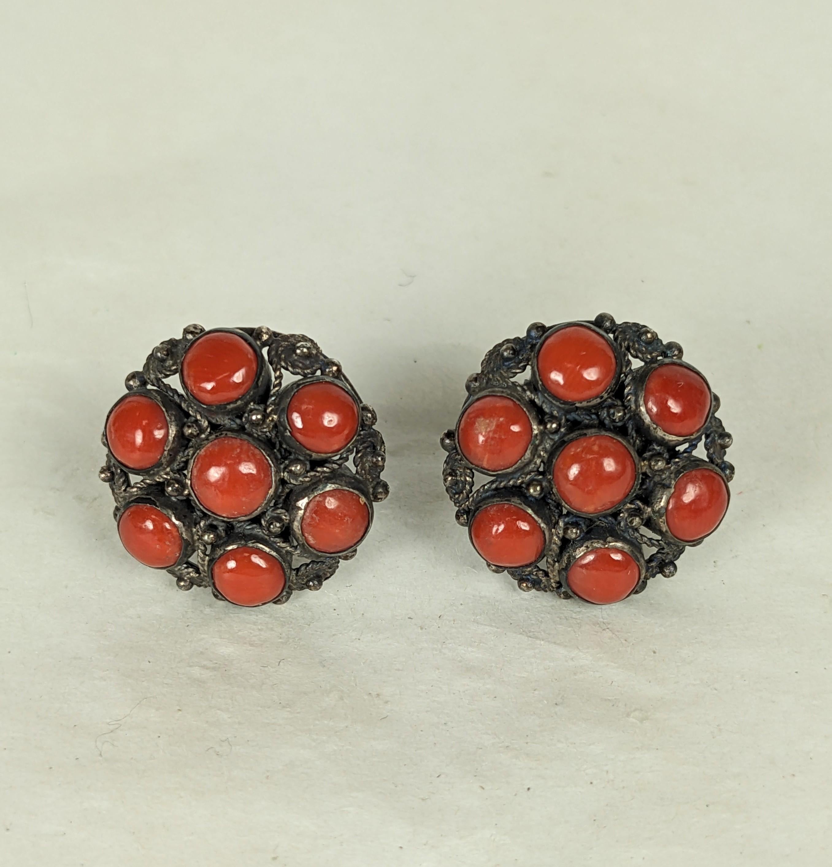 Red coral silver filigree button earclips. Of red  Sardinian coral cabocheons set in filigree wire work sterling silver, with screw back fittings. Excellent Condition. 1940's Italy. DOMESTIC SALES ONLY.
Length .75