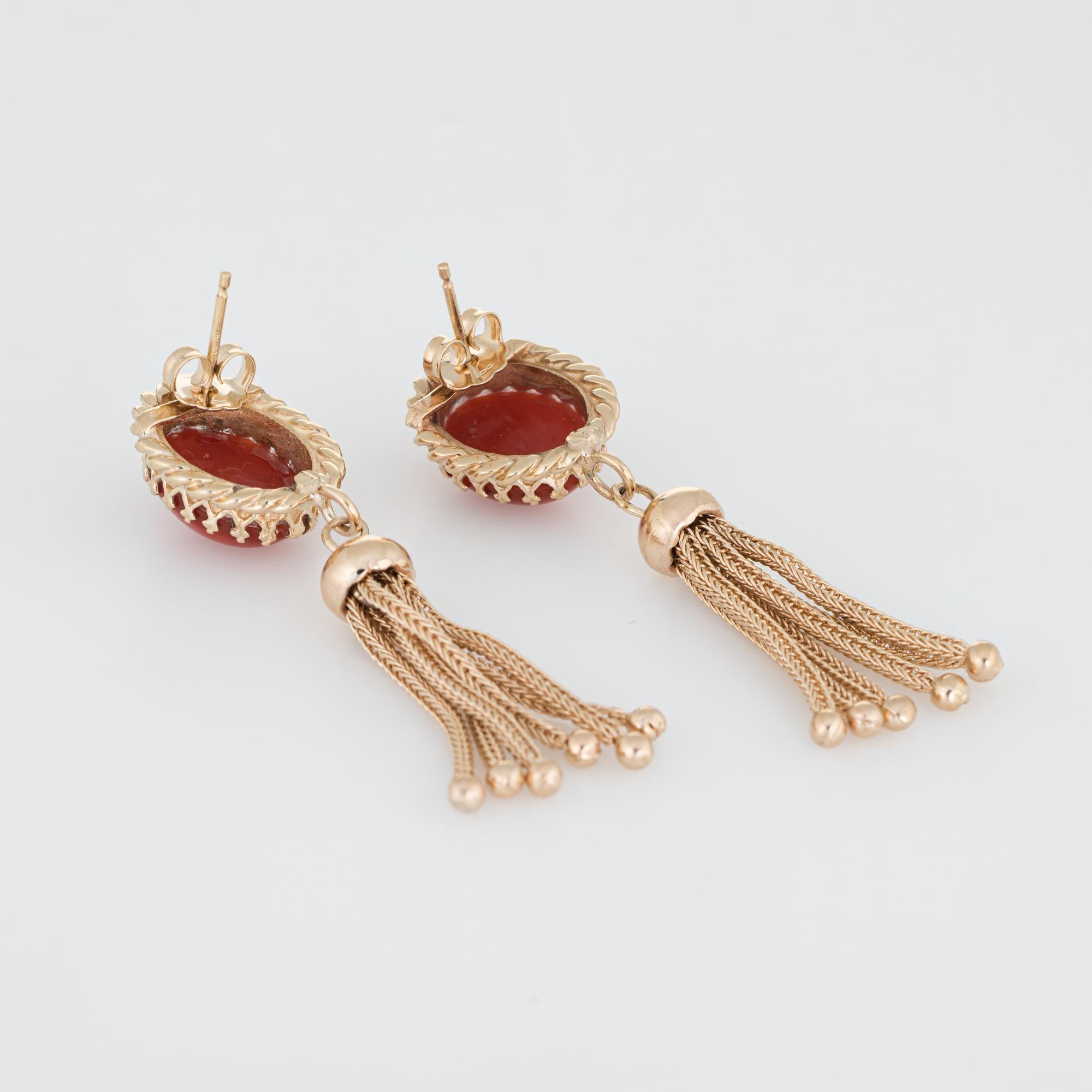 Finely detailed pair of vintage tassel earrings, crafted in 14k yellow gold. 

Mediterranean red coral each measures 12mm x 10mm (estimated at 4.50 carats each - 9 carats total estimated weight). The coral is in excellent condition and free of