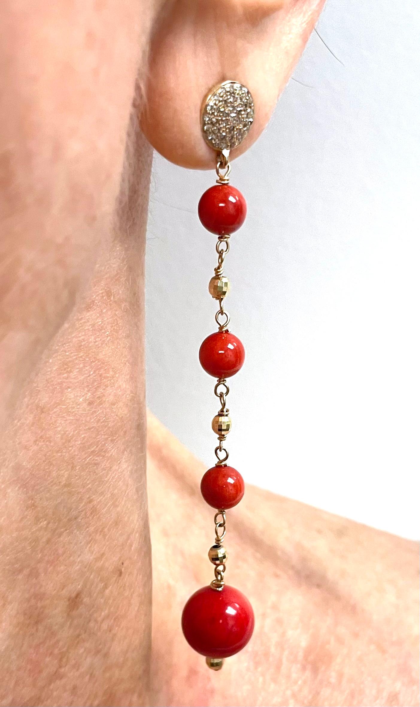 Description
Beautiful, vibrant Coral individually wire wrapped suspended from pave diamond ear posts and accented with small yellow gold faceted balls to create a harmonious feminine style. 
Item # E3361
Check out matching necklace Item # N3781 and
