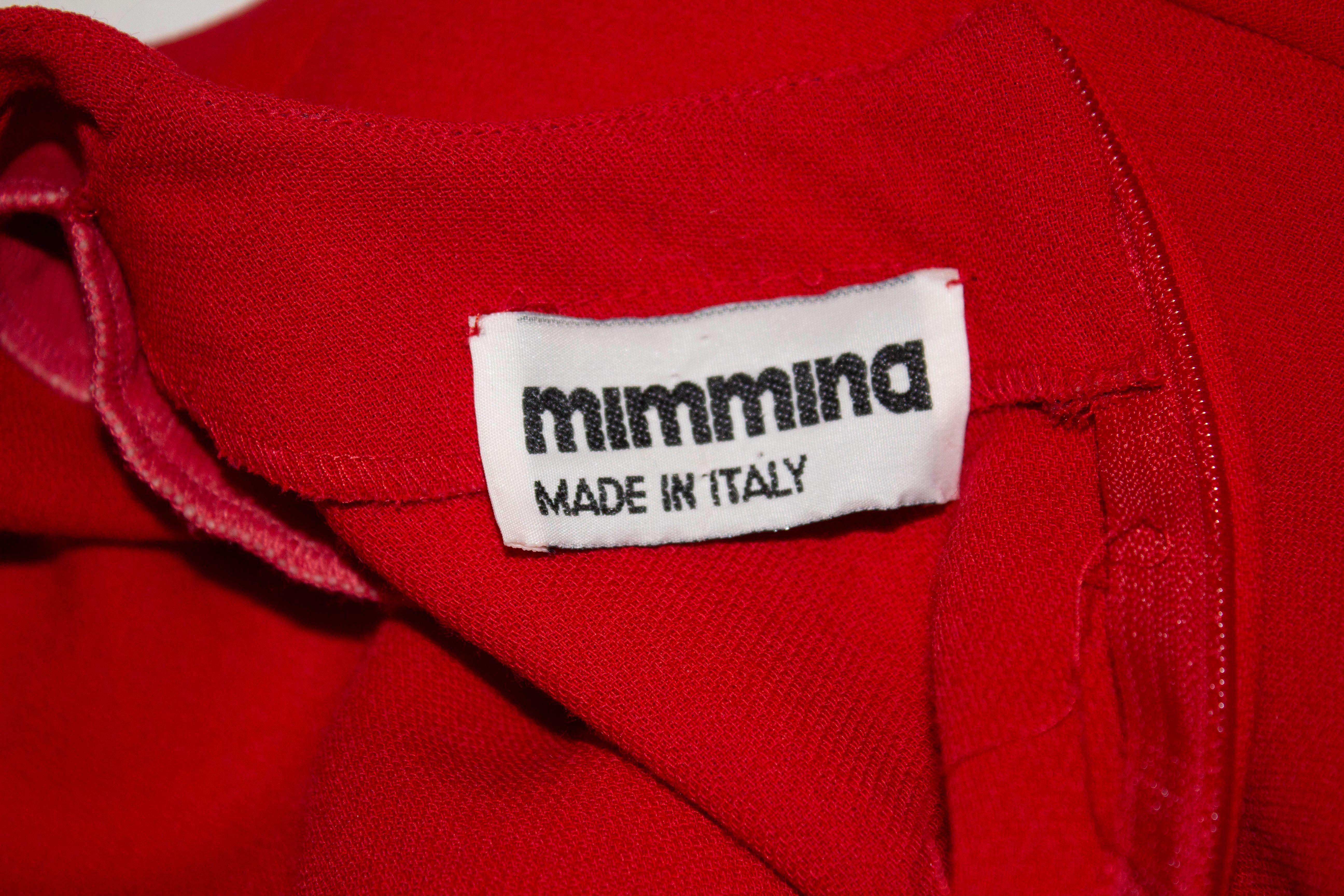 A chic and easy to wear red crepe dress by Mimmina of Italy. The dress is in excellent condition and has gathering at the front and shoulder pads. It is unlined. 

Measurements: Bust 37/8'', waist 30'', length 40''