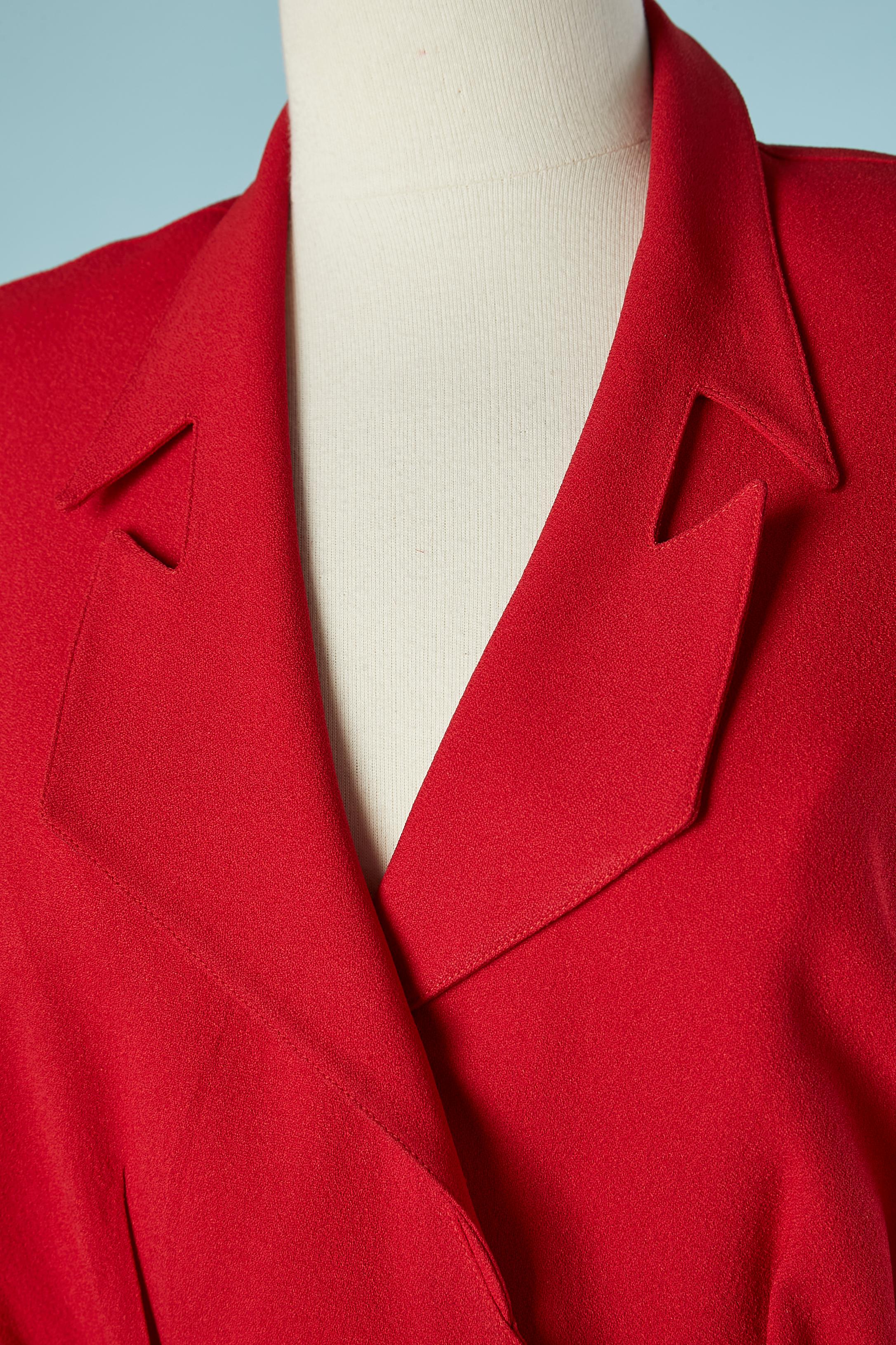 Red crêpe wrap cocktail dress with belt and red plastic buckle. Fabric composition: 51% acetate, 49% rayon. One snap inside on the waist ( to keep the wrap) and one in the middle front. Snap on the cuffs as well. Shoulder-pads. 
SIZE 38 (Fr) 8 (US)