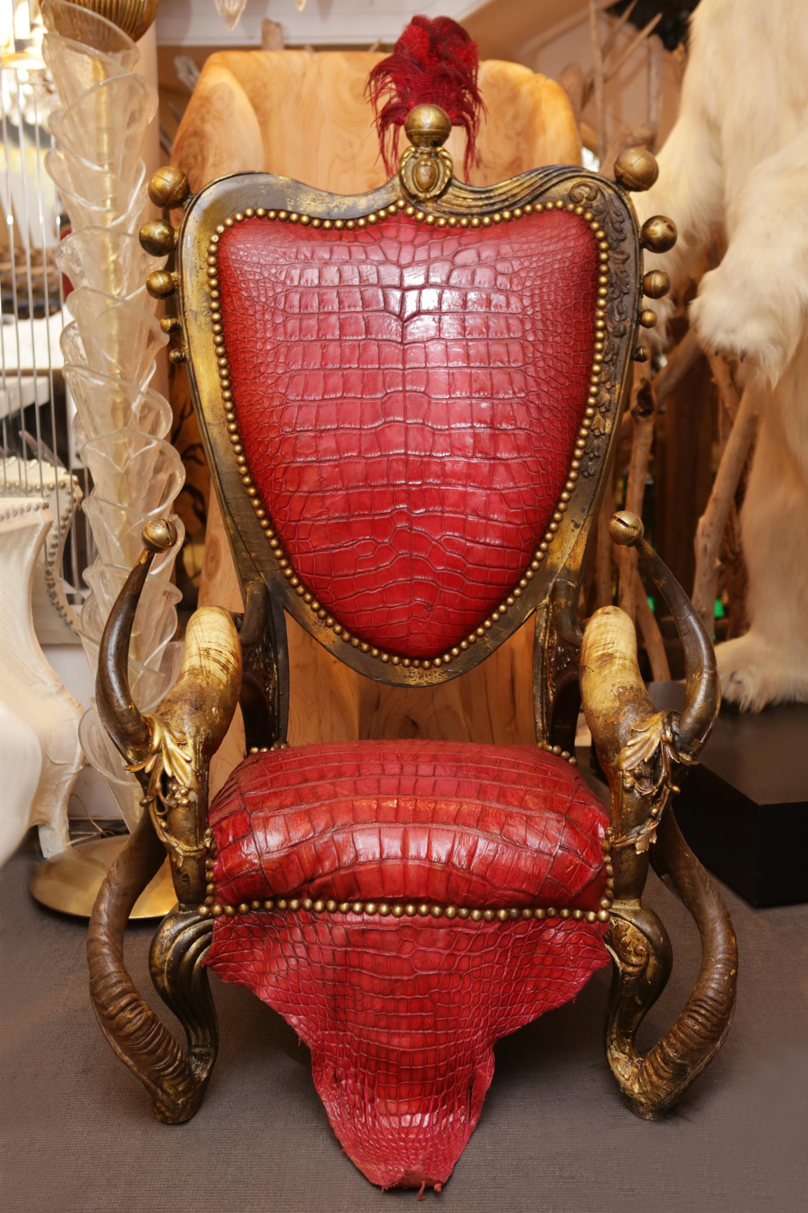 Armchair red alligator and horns made with structure in solid
beechwood. With alligator skin red tinted. Backrest with red
genuine leather. With natural real kudu horns, buffalo water
horns and with ostrich feathers on the top of the