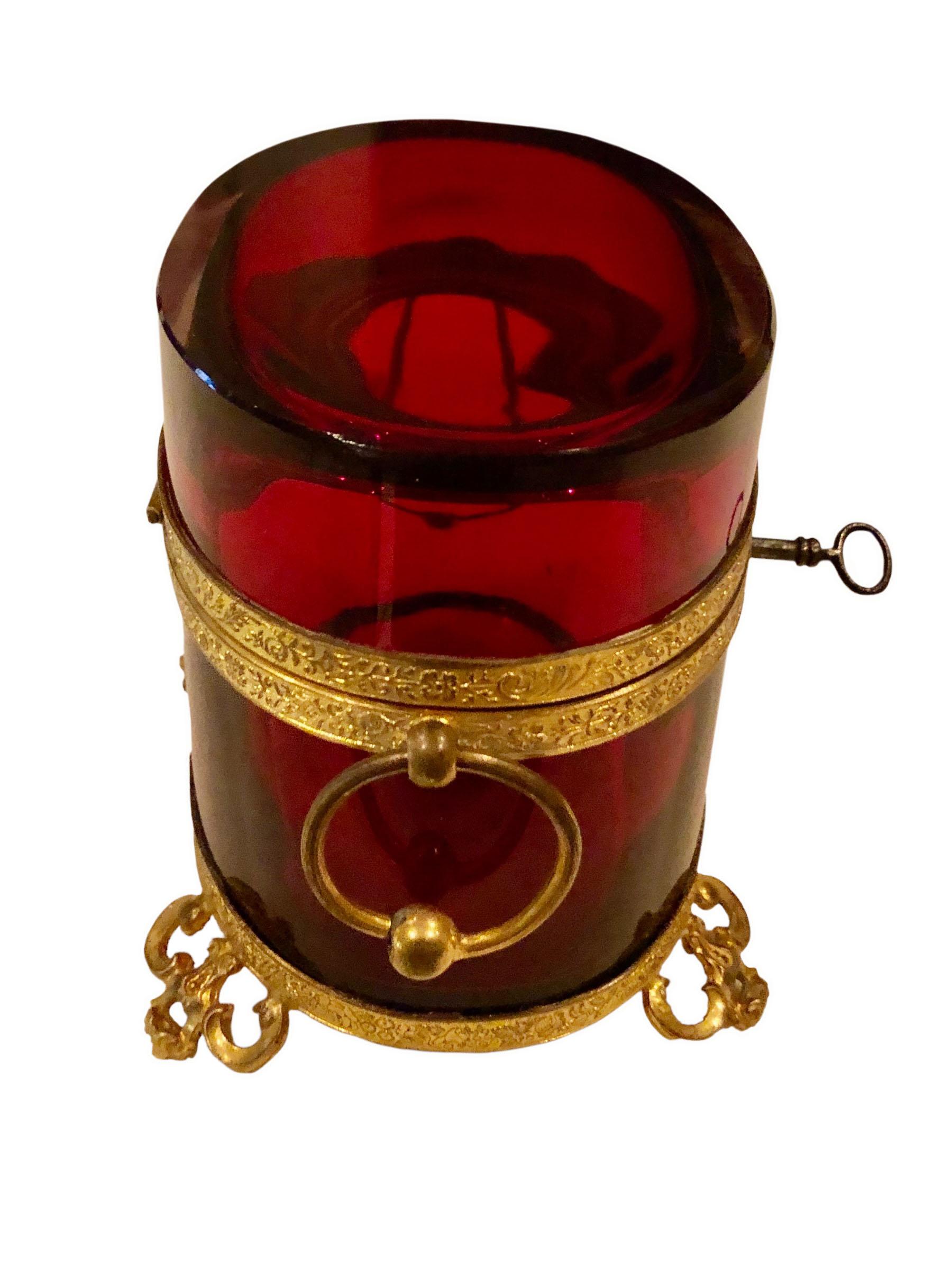Red crystal French box with bronze dore. Box has two ring handles on the sides and is strapped in bronze doré. In amazing condition no chips no scratches. Has original key.