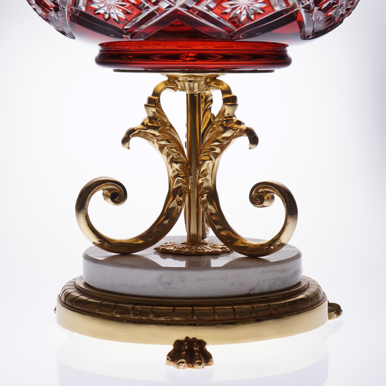 Beautiful red vase uniting crystal, marble and bronze covered with 22-carat gold

Impressive work on the 22-carat gold covered bronze. 

High quality crystal handcrafted, a lot of beautiful details are cut in the red crystal.

The crystal is