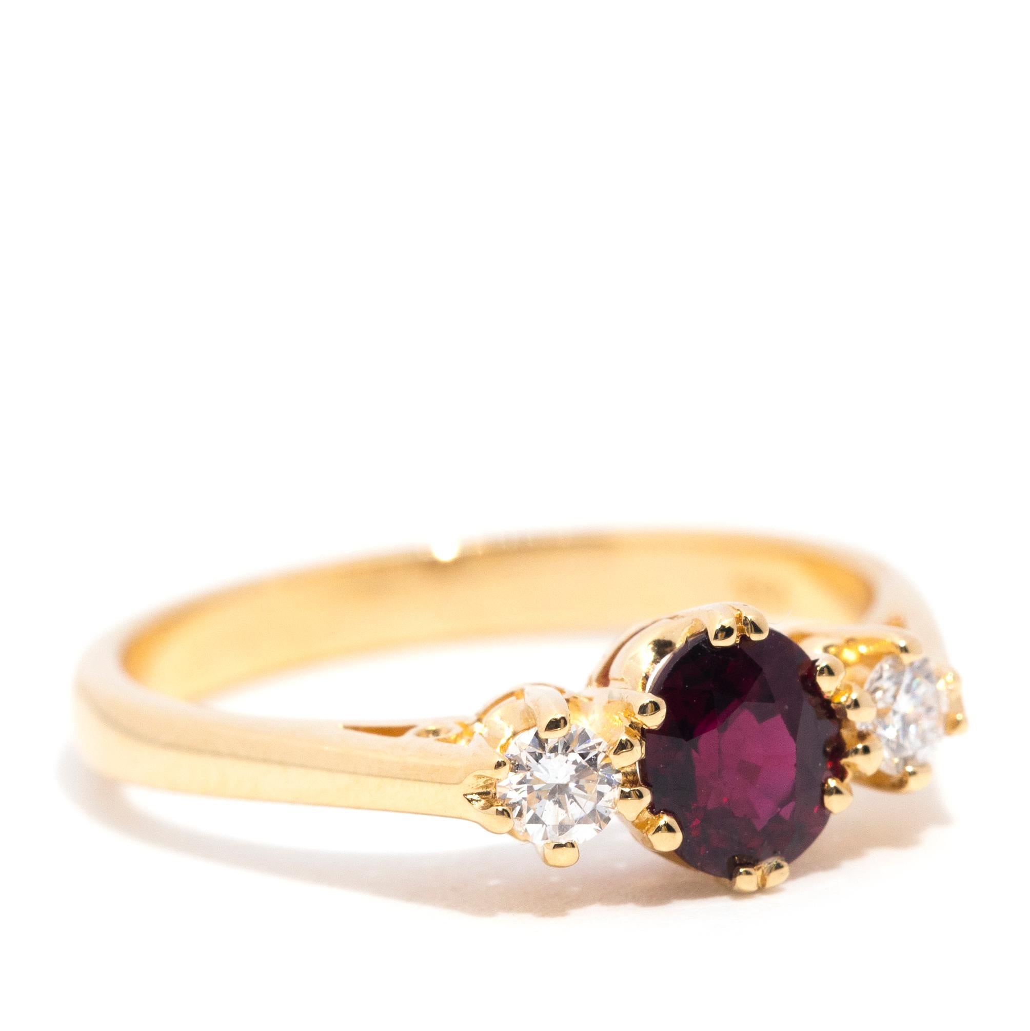 Lovingly forged in 18 carat yellow gold, this darling trilogy ring features a gorgeous deep red faceted oval ruby flanked by a beautiful pair of sparkling round brilliant cut diamonds. This vintage splendour has been named The Fawn Ring. The Fawn