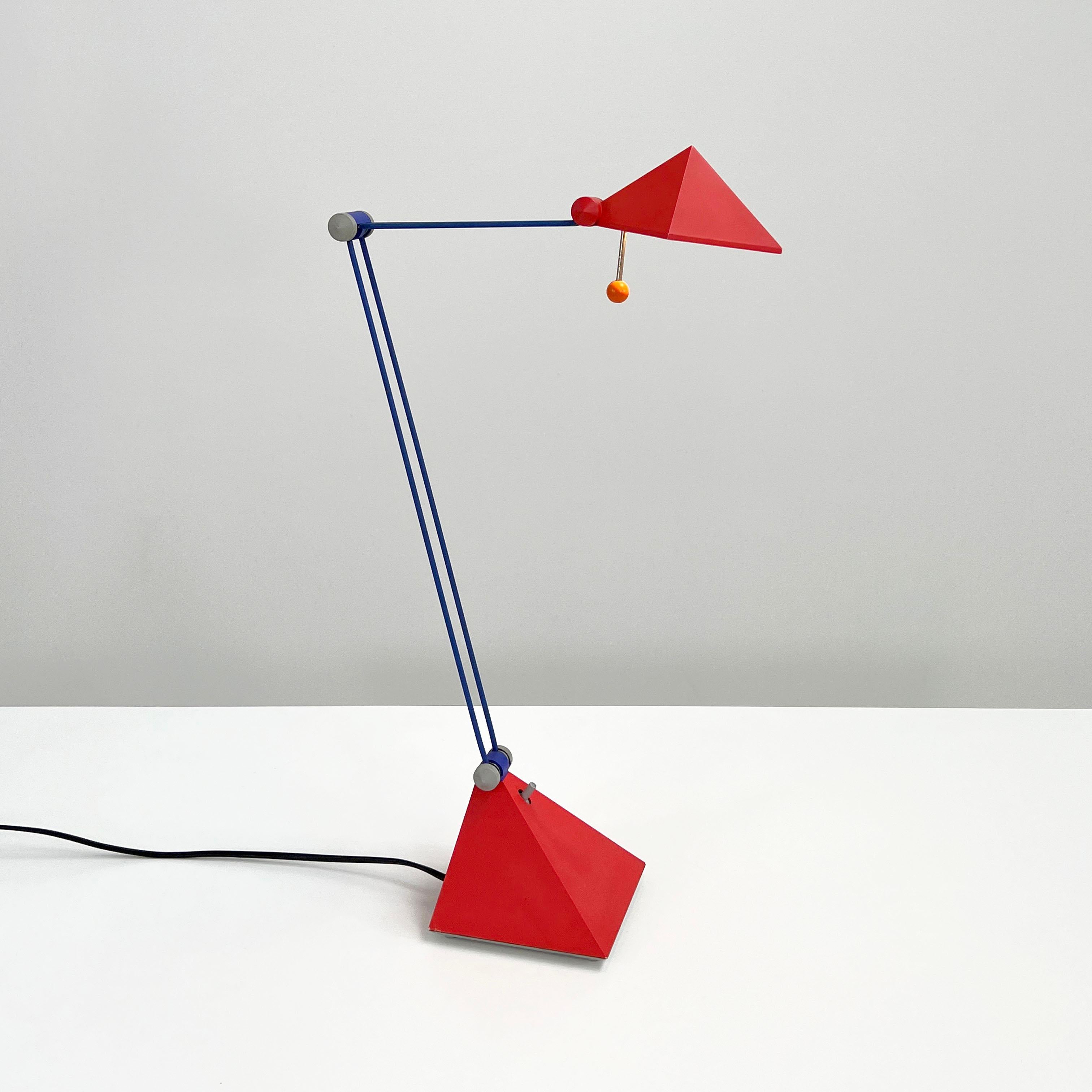 Designer - Lungean and Pellmann
Producer - Brilliant Leuchten Germany 
Design Period - Eigthies
Measurements - Width 14 cm x Depth 40 cm x Height 55 cm
Materials - Metal, Plastic
Color - Orange, Blue, Red, Grey
Light wear consistent with age and
