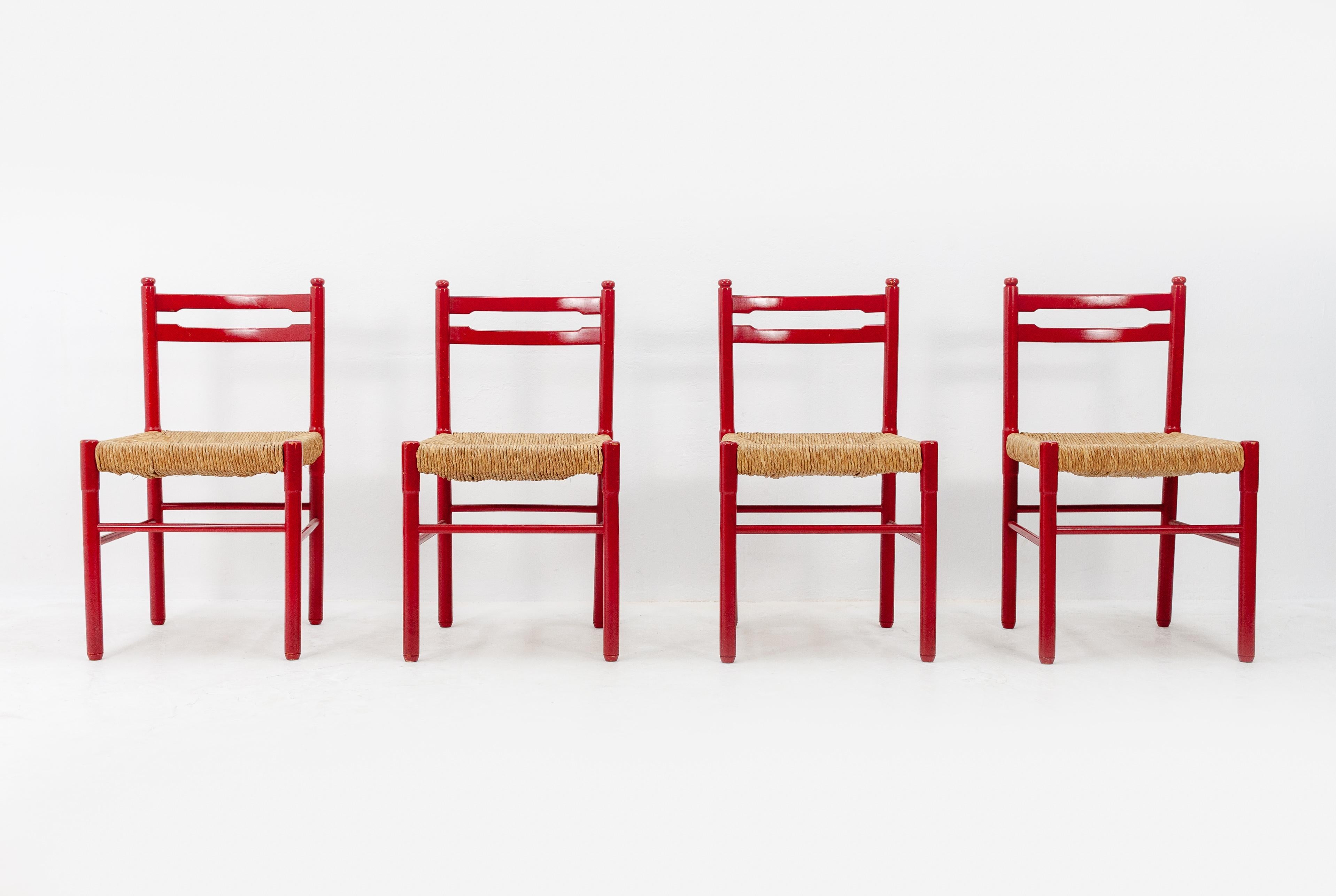 Four very nice funky red dining chairs, bright red beech wood frames with rattan seats. The style is very similar to Vico Magistertti designs. The chairs are in very good condition and this is their original color, 1960s.
