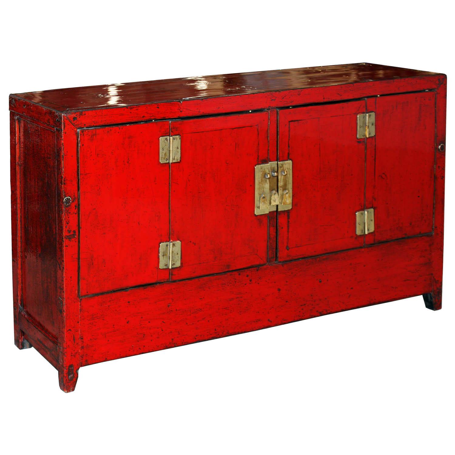 Red lacquer buffet with tapered legs and straight skirt. New interior shelf, hardware and accordion doors. Use in the living or dining room as a server with plenty of storage.