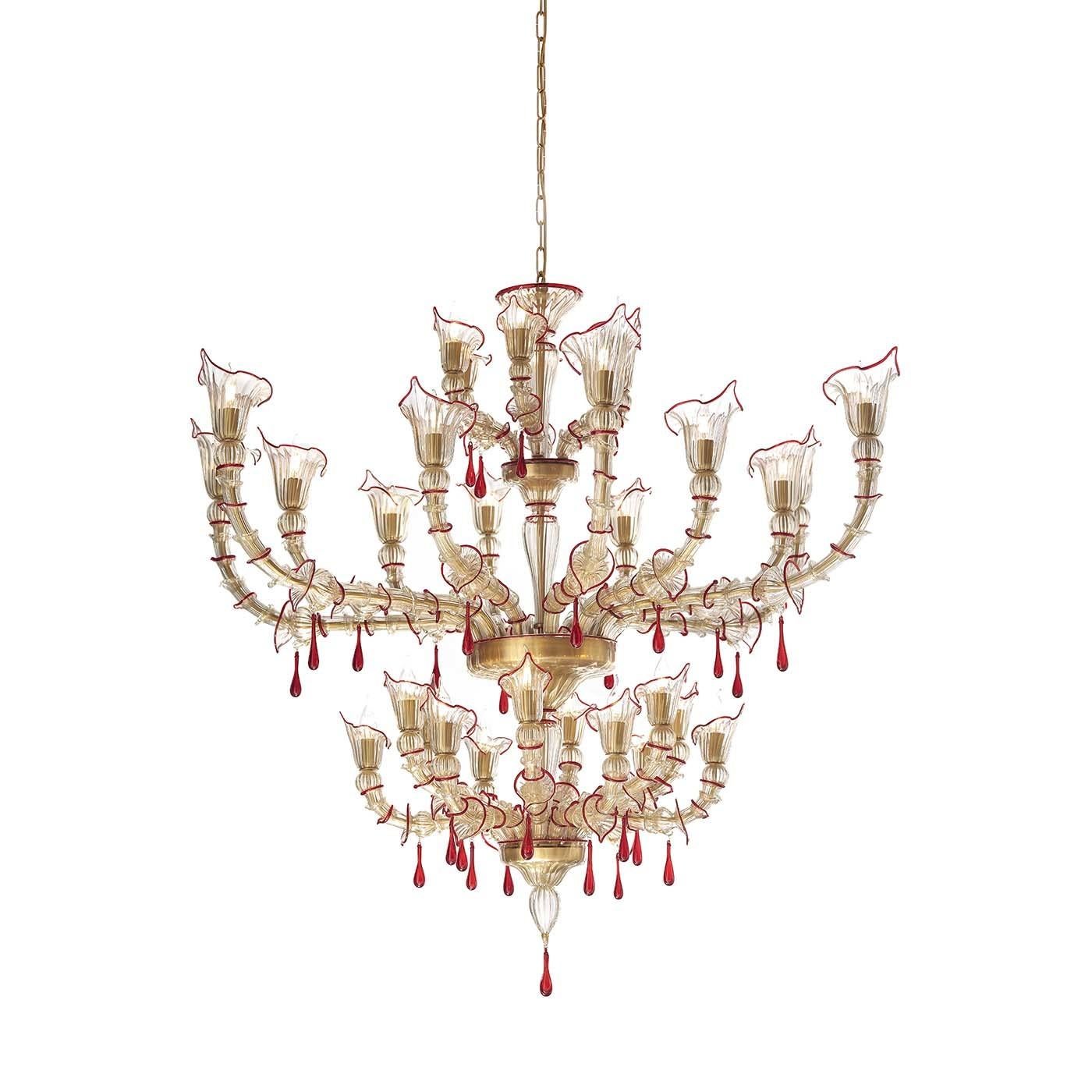 Build on three tiers, this Murano glass chandelier is the epitome of grace and refinement. Decorated from bottom to top with gold and red decorations, the imposing yet light structure is handcrafted in the Ca' Rezzonico style, illuminated by thirty