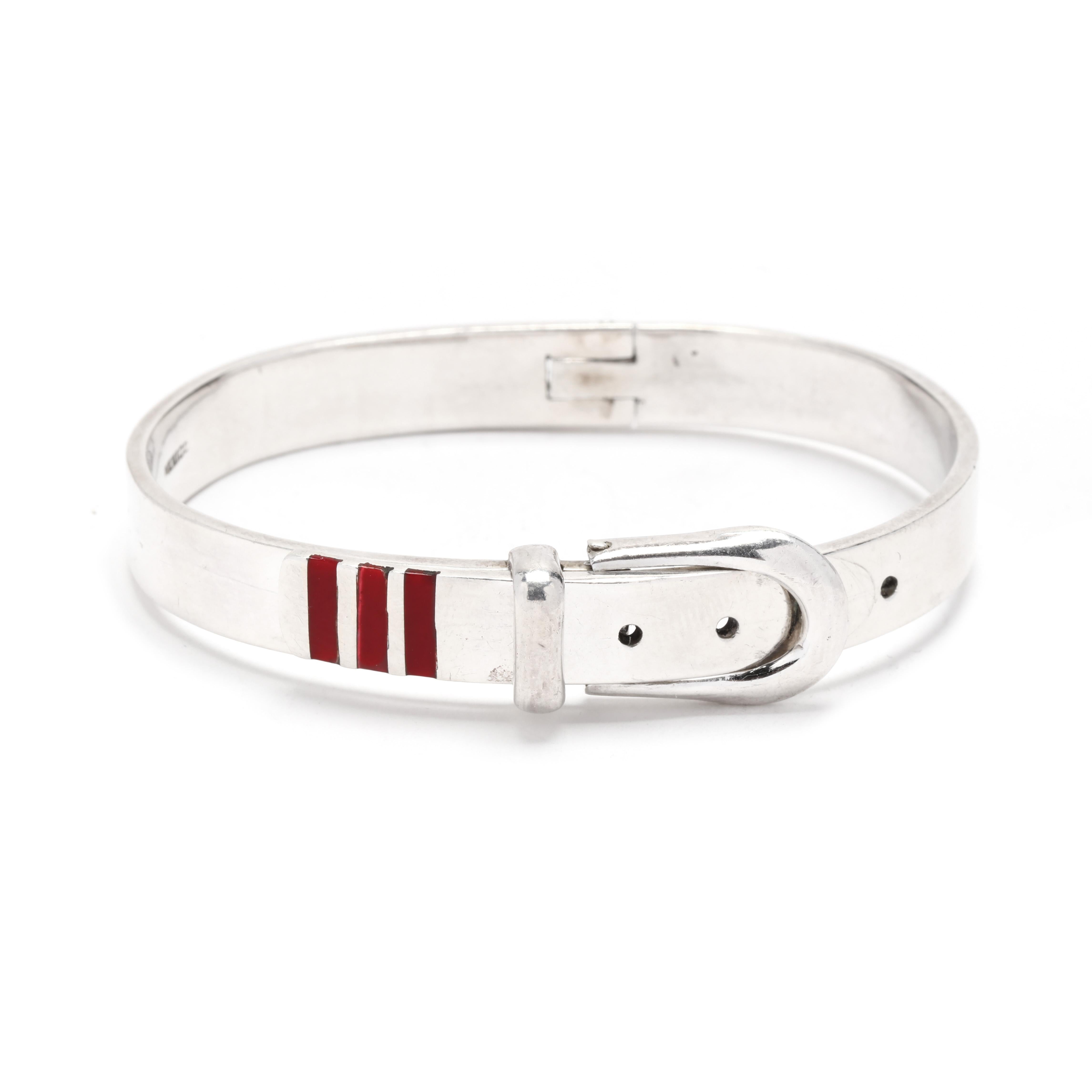 A vintage sterling silver red enamel belt buckle motif hinged bangle bracelet.  This bracelet features a belt buckle design with three bands of red enamel inlay.  It is hinged and the buckle serves as the clasp.  It is stamped 925 Mexico.

Length: