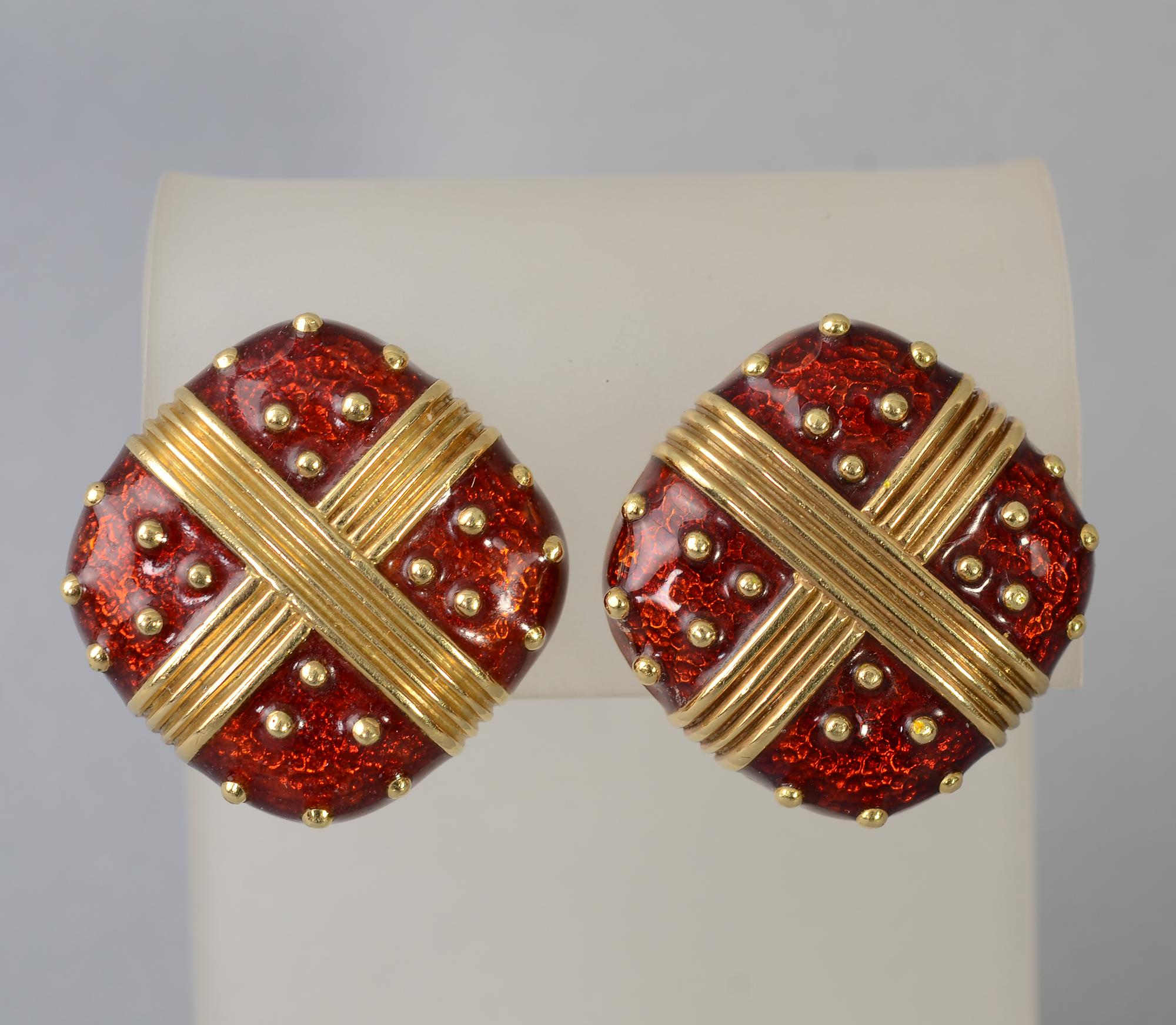 Stylish 18 karat gold and red enamel earrings. The gold criss cross is filled with six gold dots in each quadrant. One back has a clip and post. The post is missing from one of the earrings. It can easily be replaced or the existing one removed for