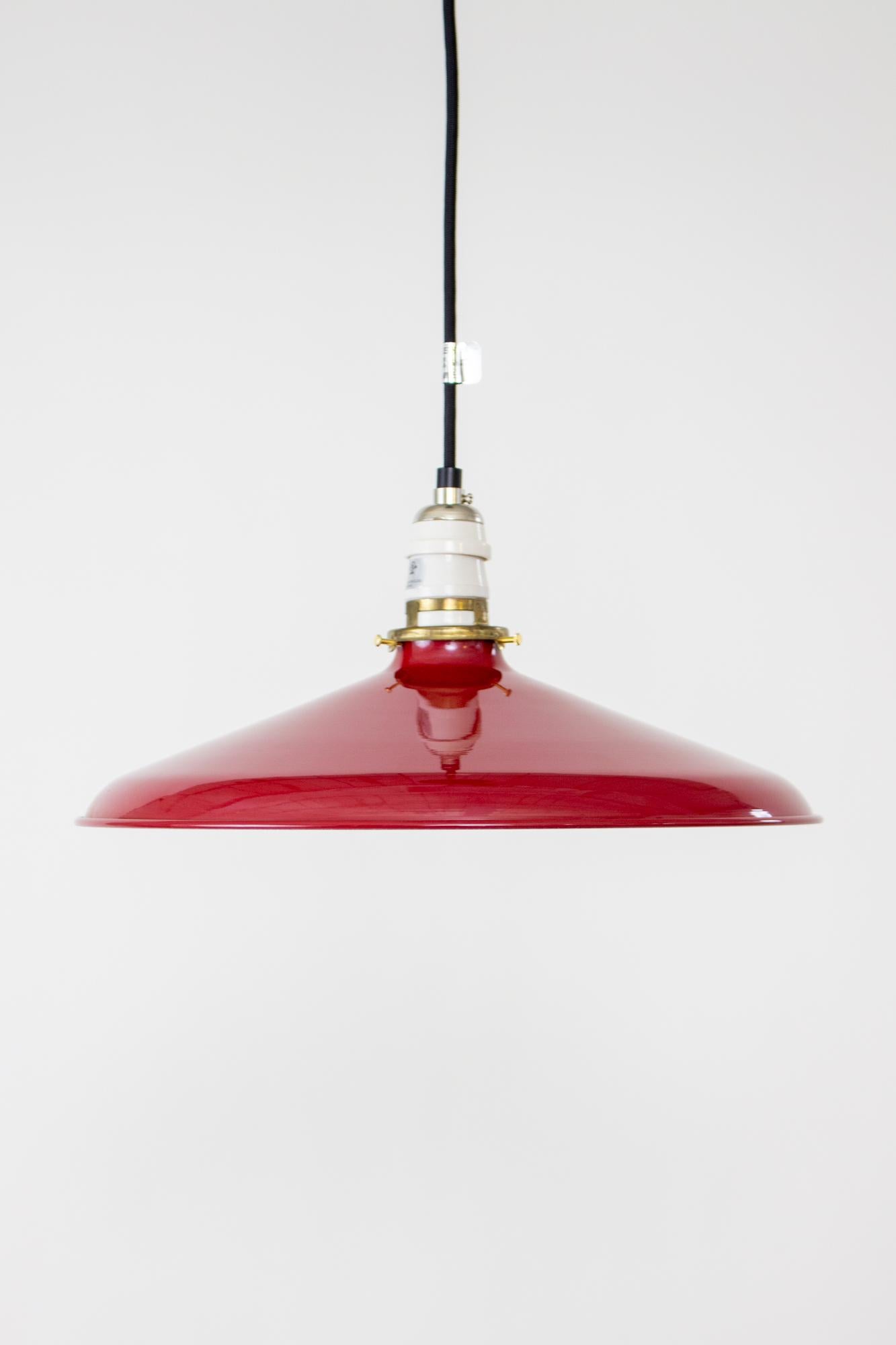Red enamel industrial pendant. Black cord and canopy, porcelain antique style socket, antique clamp fitter and milk glass disk shade. Shown with Edison style bulb as a style suggestion, bulb is not included. Fixture is adjustable from 11