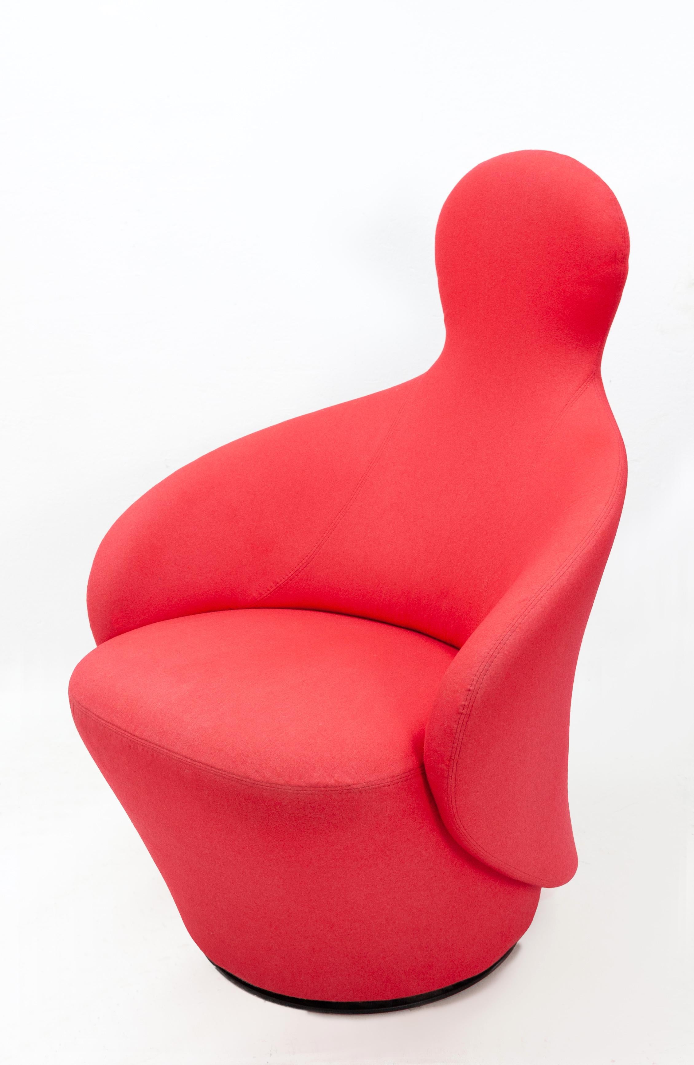 A chair that looks like it embraces you when you sit in it. Upholstered in a red felt and mounted on a rotating base.
Good condition and a quality piece.