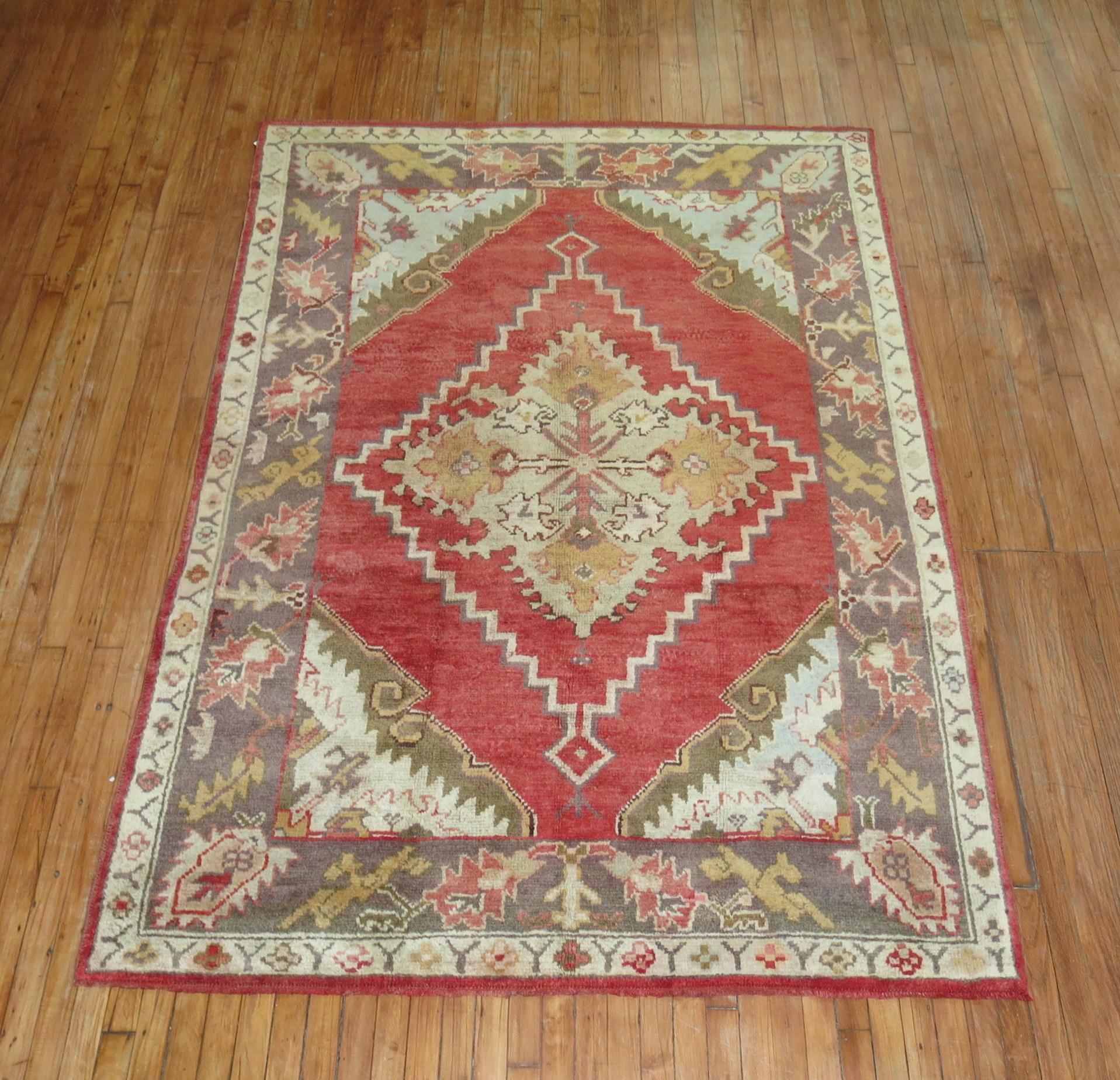 Early 20th-century Turkish Oushak rug with a medallion and border pattern on a red field

Measures: 5'7
