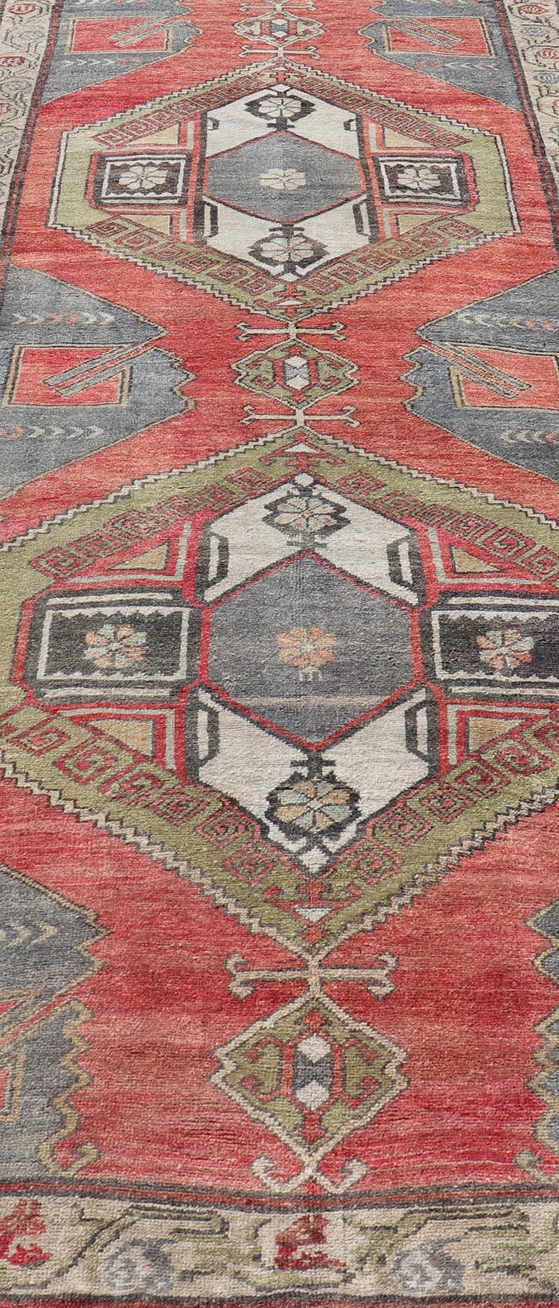 20th Century Red Field Vintage Turkish Oushak Gallery Runner with A Geometric Design For Sale