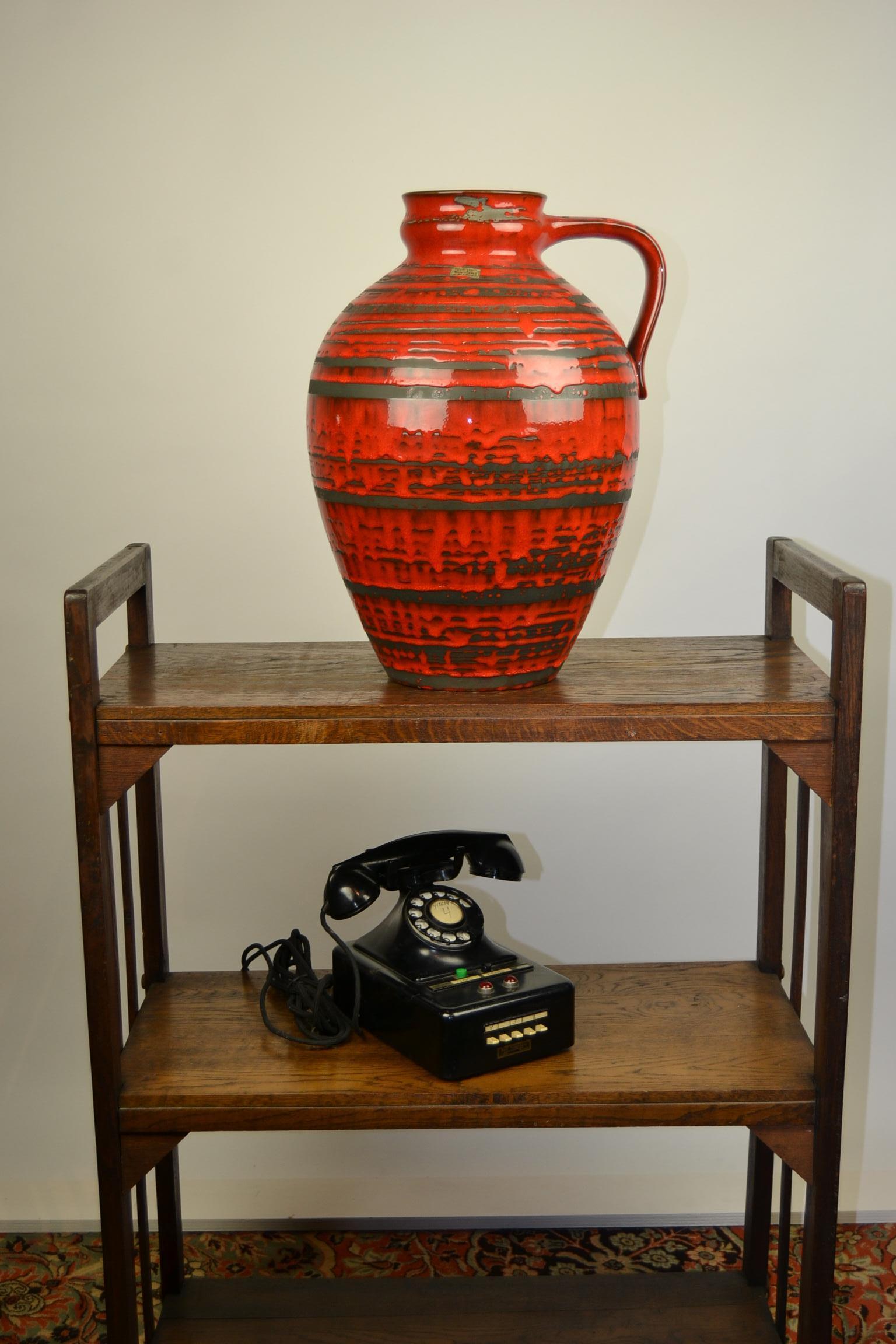 Large handled floor vase by Pottery Carstens Tönnieshof, West Germany.
Vintage fat lava red ceramic vase. Height: 17.71 inch (45 cm)
Modern design and great combination of colors orange/red and grey.
Signed: 6010 - 45 W- Germany.
Floor vase,