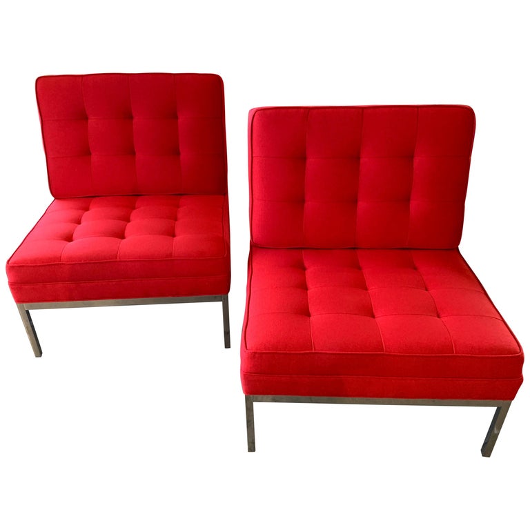 A pair of vintage Florence Knoll lounge chairs on steel bases. We have these totally refurbished and re-upholstered in red Maharam Messenger fabric. The bases have been polished, and the chairs look nice, with some minor marks to the bases.