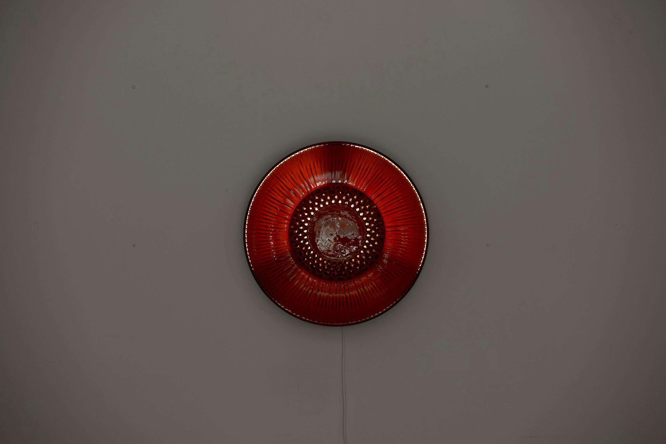 Red ceramic wall lamp, 1960s. Socket: 1xE36. We have a second, almost identical lamp listed, too. Please note: Lamp should be fitted professionally in accordance to local requirements.