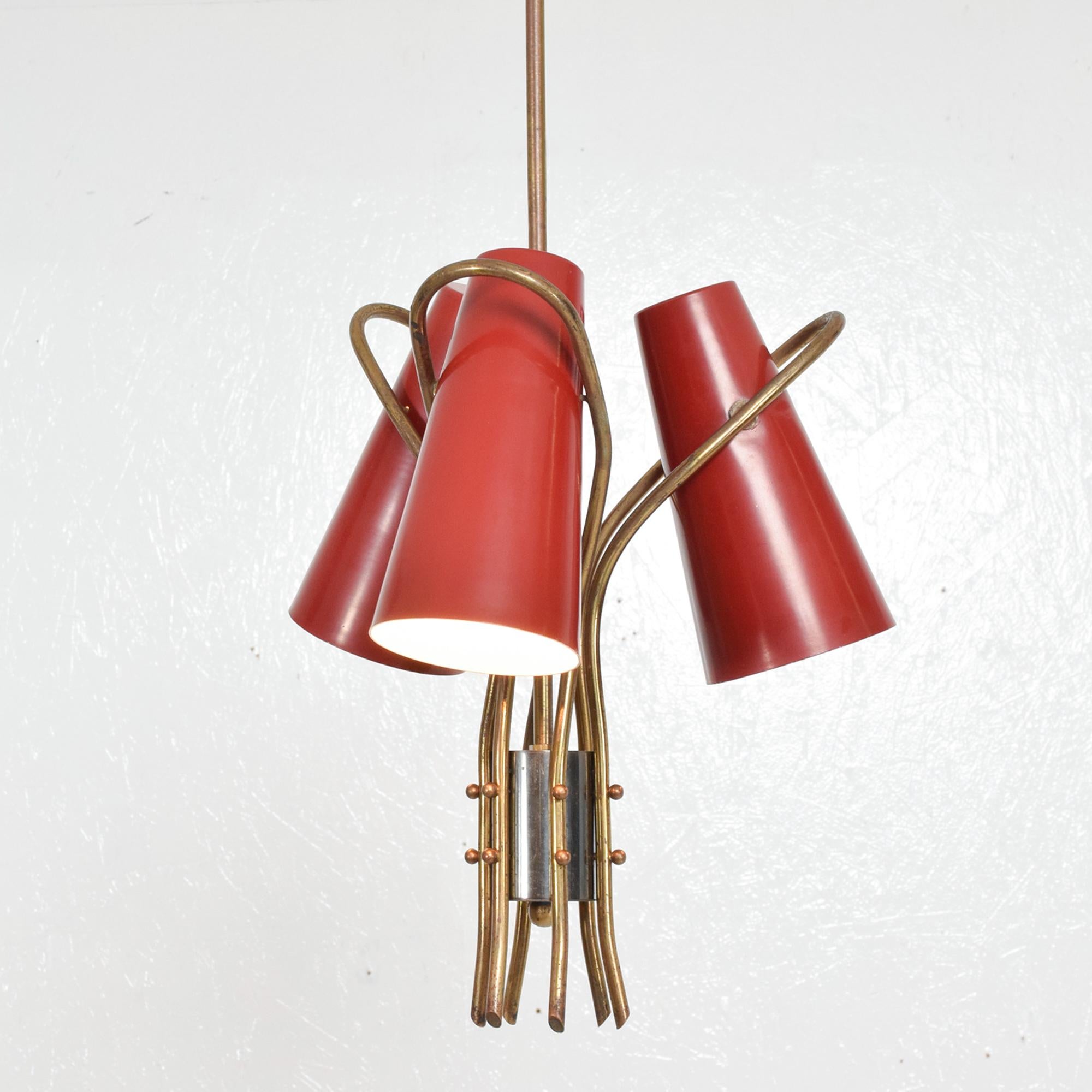 French red hanging chandelier lamp modern design features a trio of lights.
Curved sculptural brass construction aluminum cones painted in red.
No markings or label present from the maker. In the style of Pierre Guariche.
Dimensions: 28