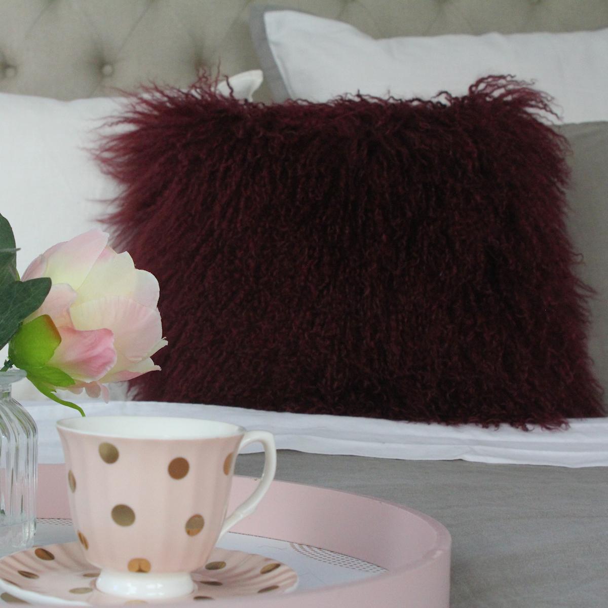 Create an atmosphere of designer style comfort layering a sofa or bed with this alluring, wine red fur pillow. Handcrafted from the finest Mongolian Sheepskin boasting with supreme fur like qualities making this Mongolian sheepskin pillow, feel and