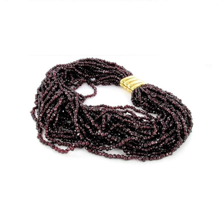 This massive torsade is consisting of 25 rows of rough, polished dark red garnets. 
Torsade is a style of necklace which can be twisted to adjust length and change style. Do to the individual gem strands the necklace will lay nicely on your