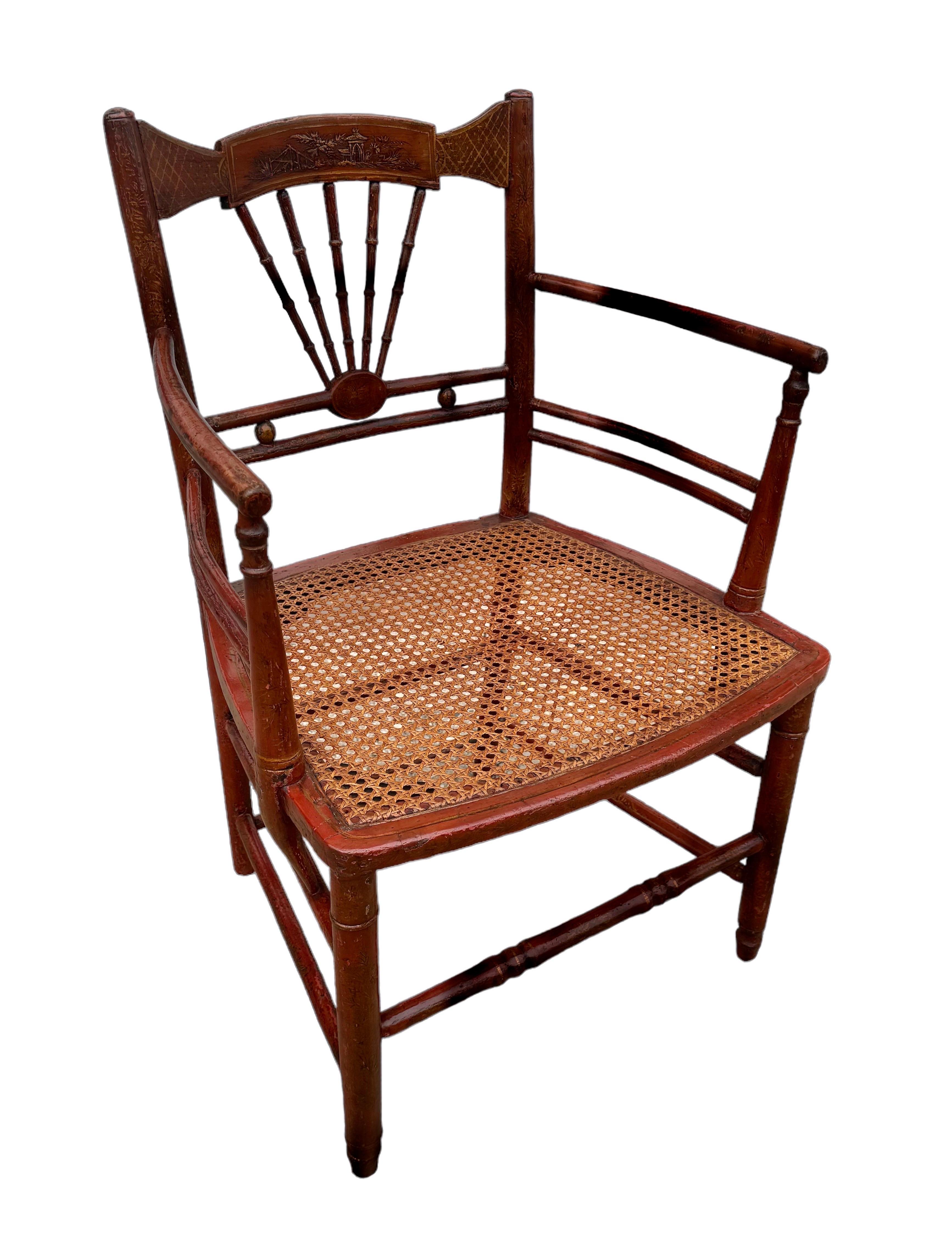 Sillón de chinoiserie pintado en rojo y dorado con asiento de caña