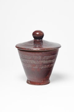 Red glazed ceramic covered pot by Jean Maubrou, circa 1940-1950