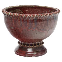 Red glazed ceramic footed bowl by Jean Maubrou, circa 1940-1950