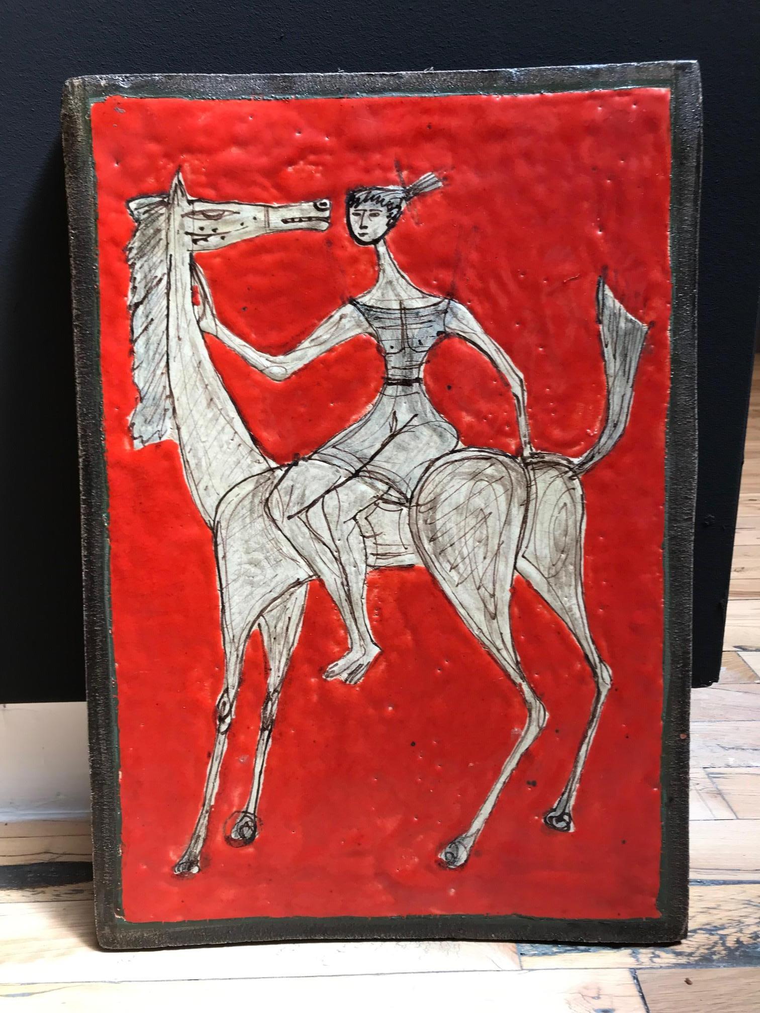 Red glazed ceramic Italian plaque of a woman on a horse in the style of Marcello Fantoni.