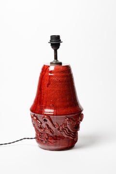 Red glazed ceramic table lamp by Jean Austruy, circa 1960.