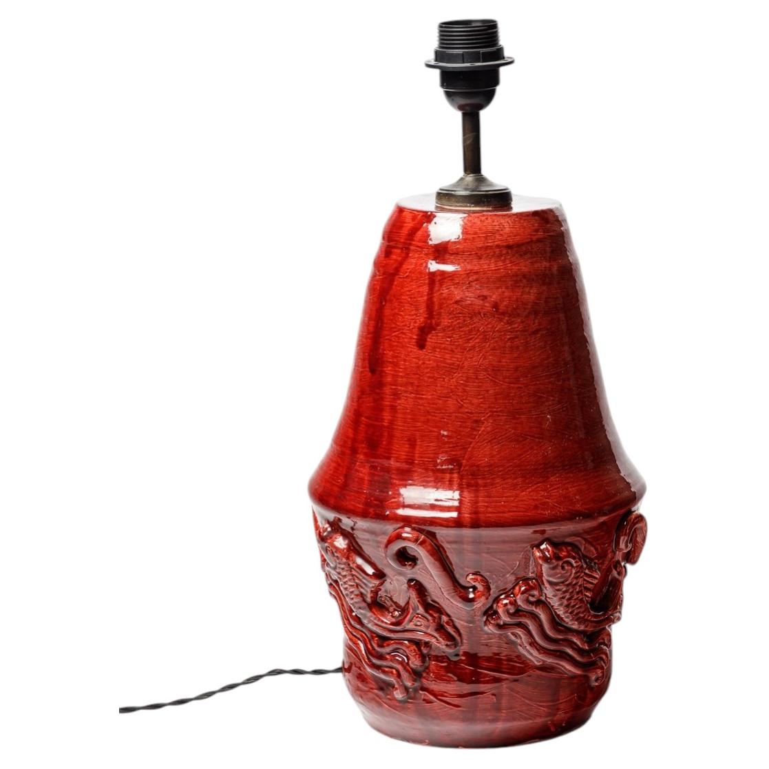 Red glazed ceramic table lamp by Jean Austruy, circa 1960. For Sale