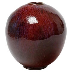 Red glazed ceramic vase by Michel Lanos